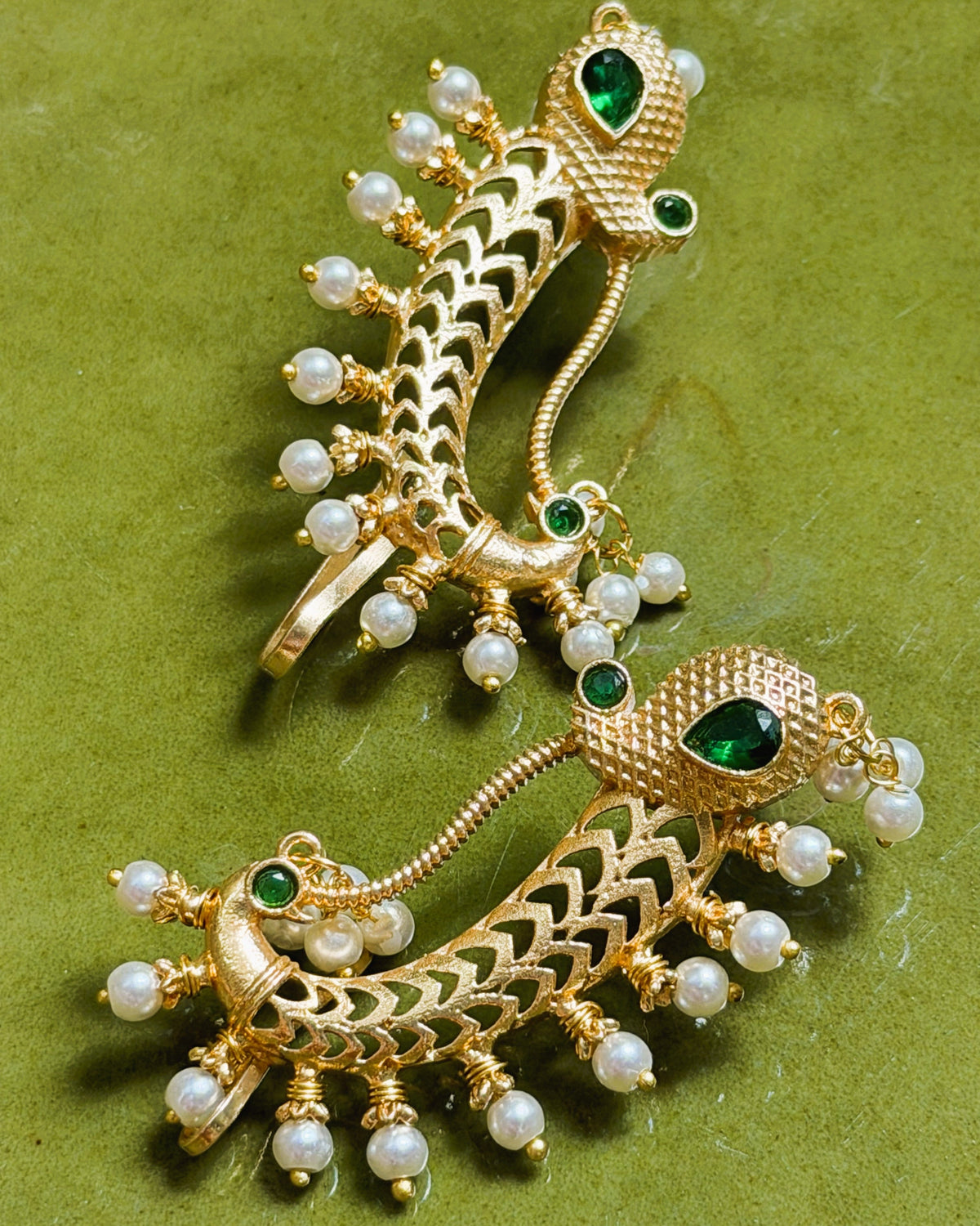 Traditional Indian earrings with peacock motif and pearl embellishments