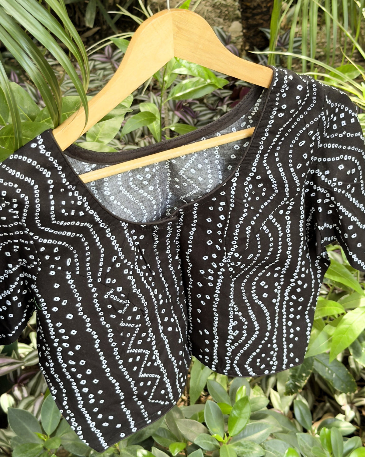 close up of black blouse with traditional white bandhej dotted pattern