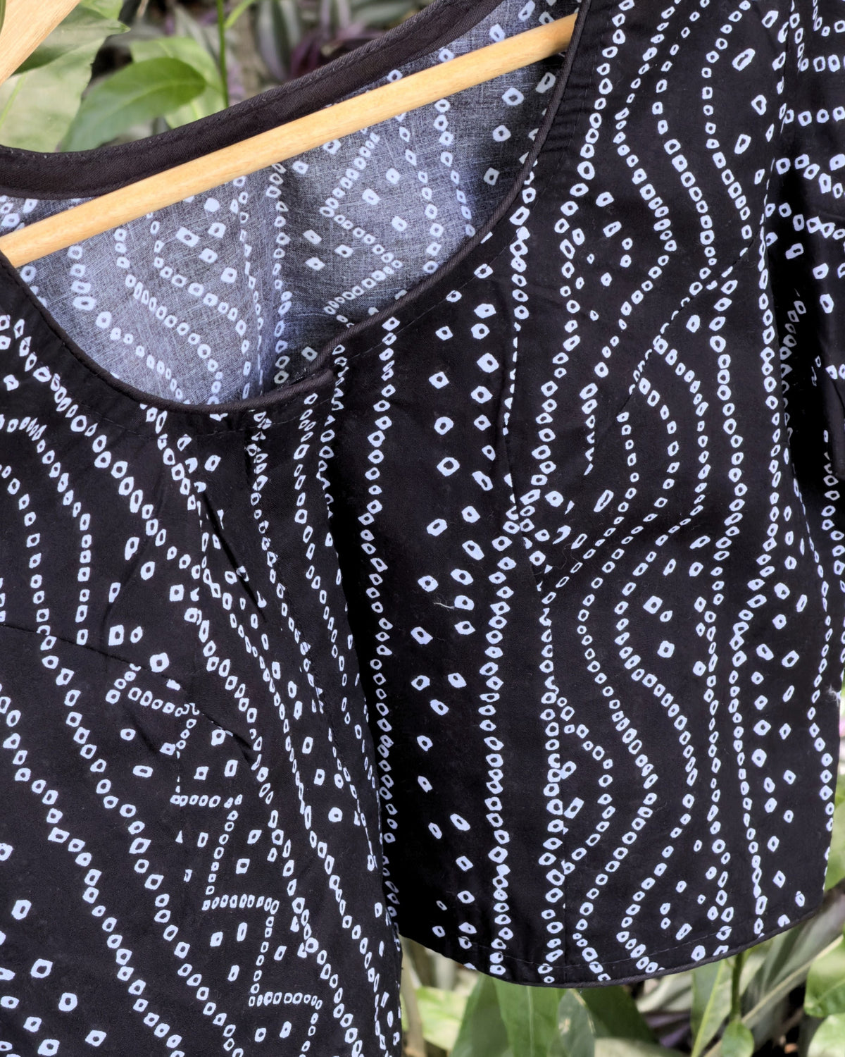 black bandhej blouse with round neckline and white dotted print