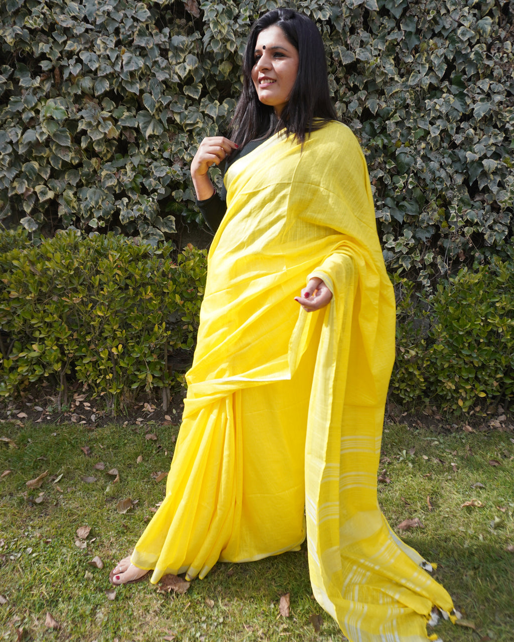 Border detail of bright yellow pure linen saree highlighting intricate zari work and craftsmanship
