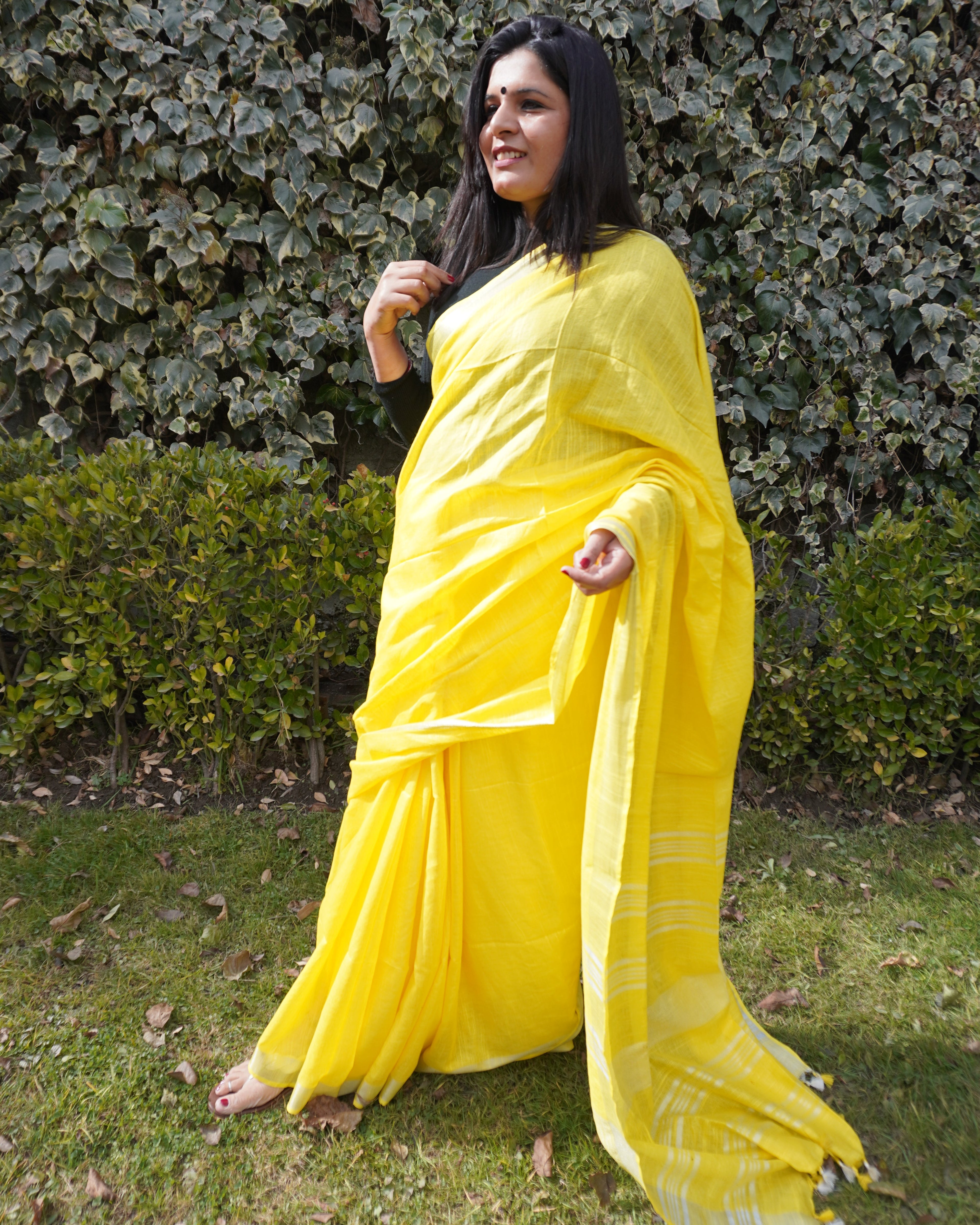 Border detail of bright yellow pure linen saree highlighting intricate zari work and craftsmanship