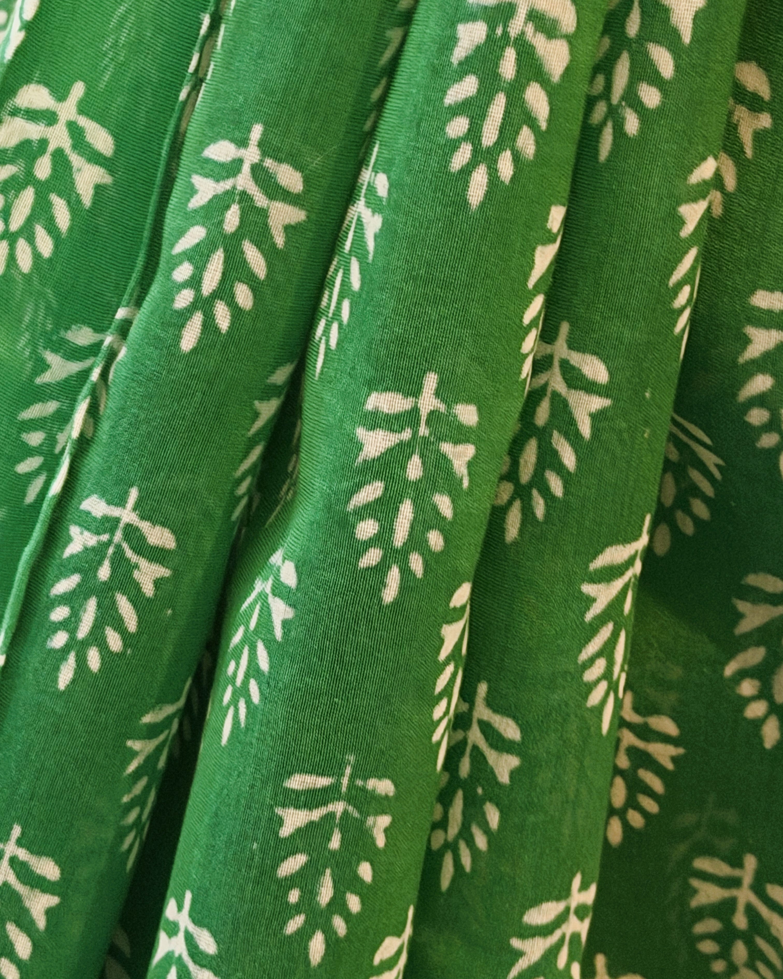 Close-up of green leaf motifs on Maheshwari silk saree fabric