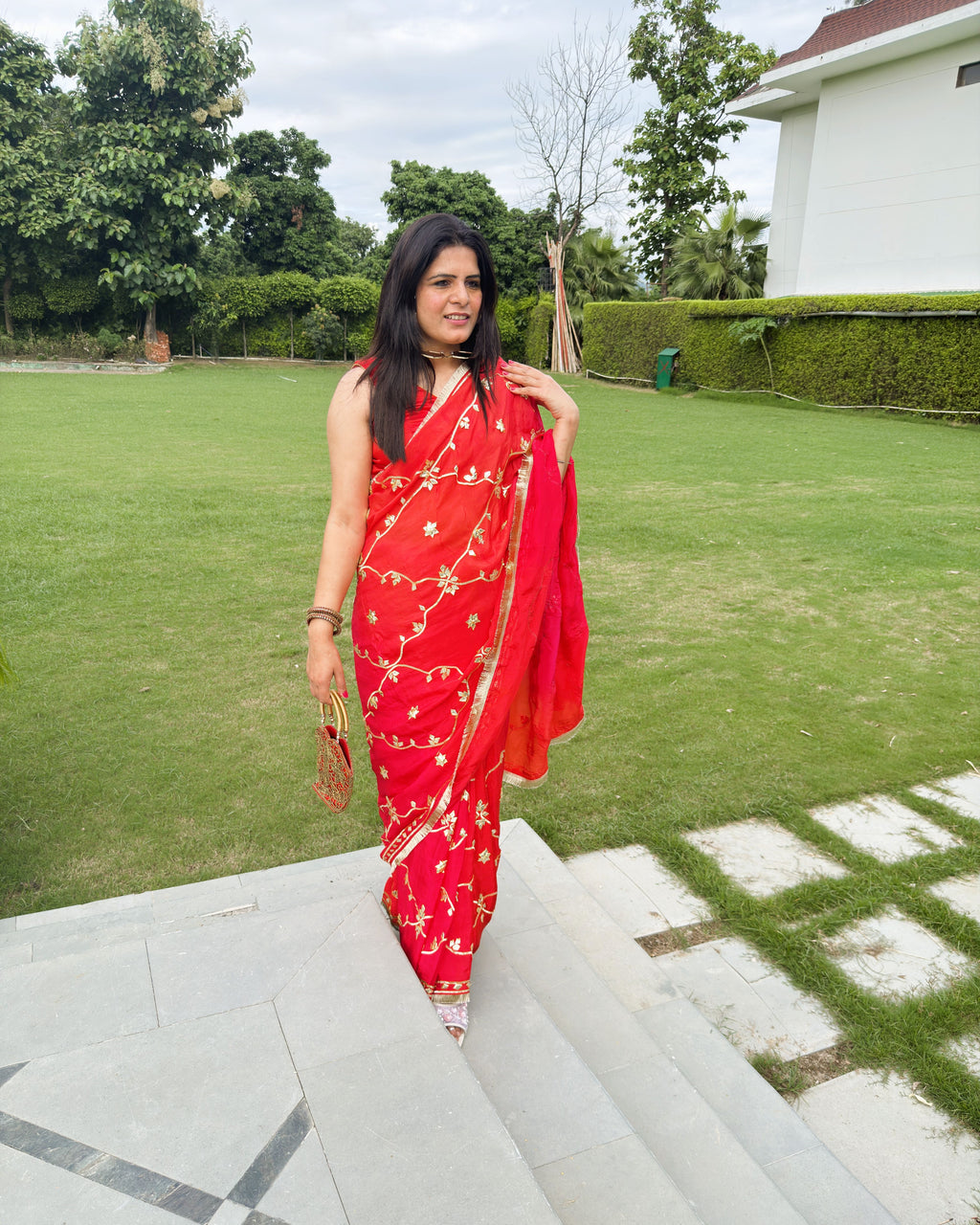intricate gold floral and leaf gotta patti motif on red HO silk saree