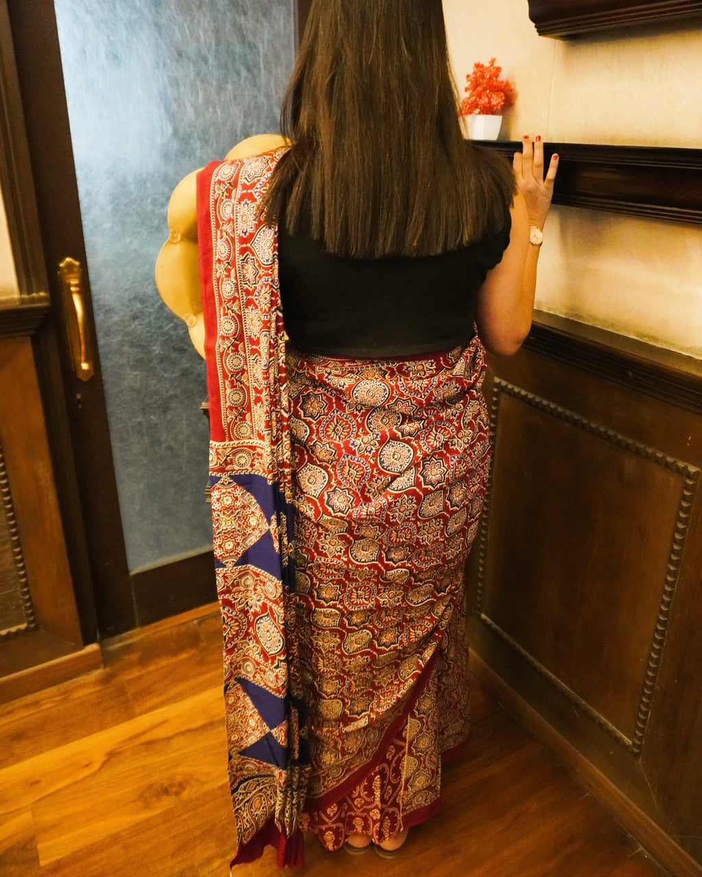 Back view of maroon and blue Ajrakh print mul cotton saree showcasing pallu design and elegant fall