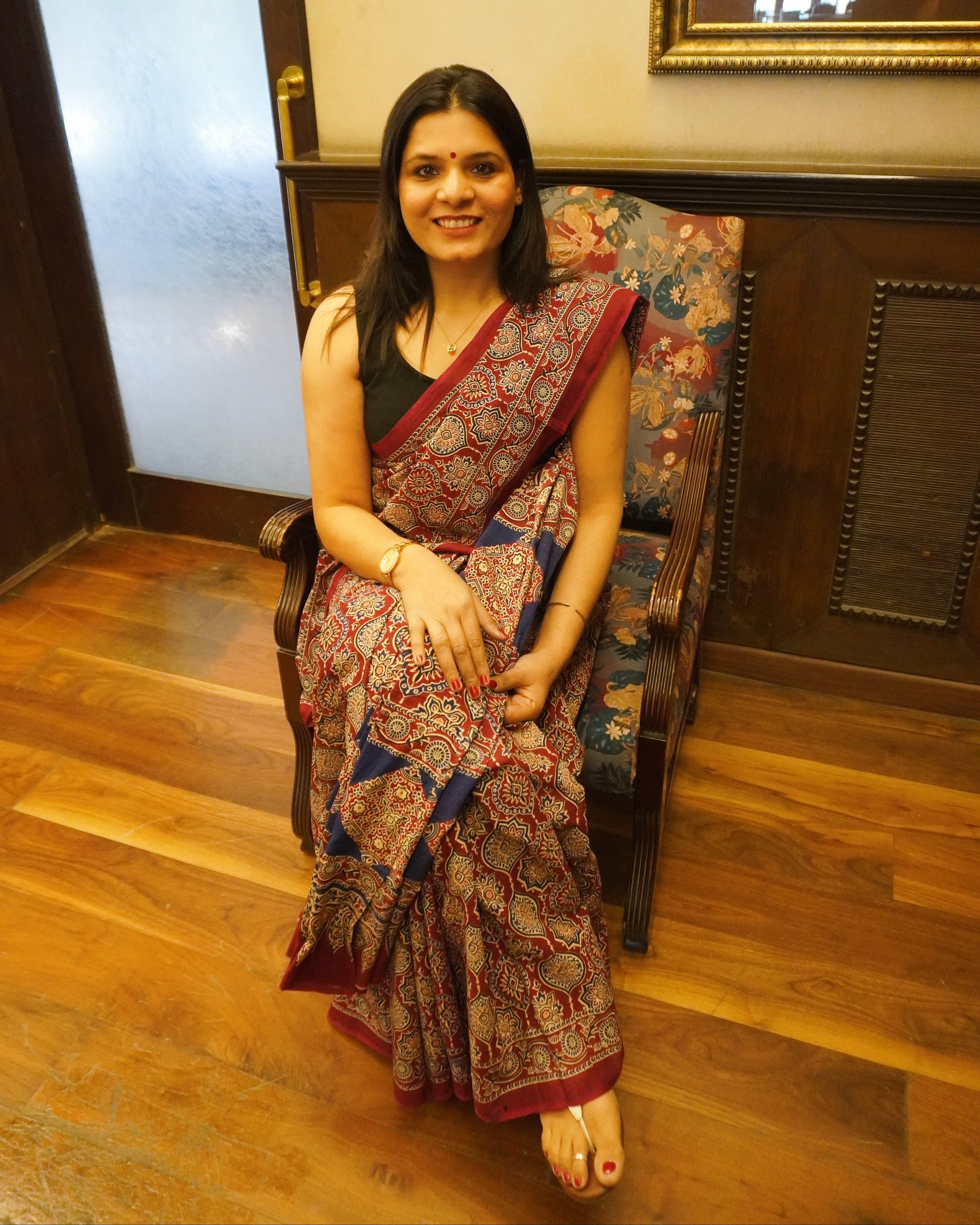 Front view of maroon and blue Ajrakh print mul cotton saree showcasing full drape and traditional patterns