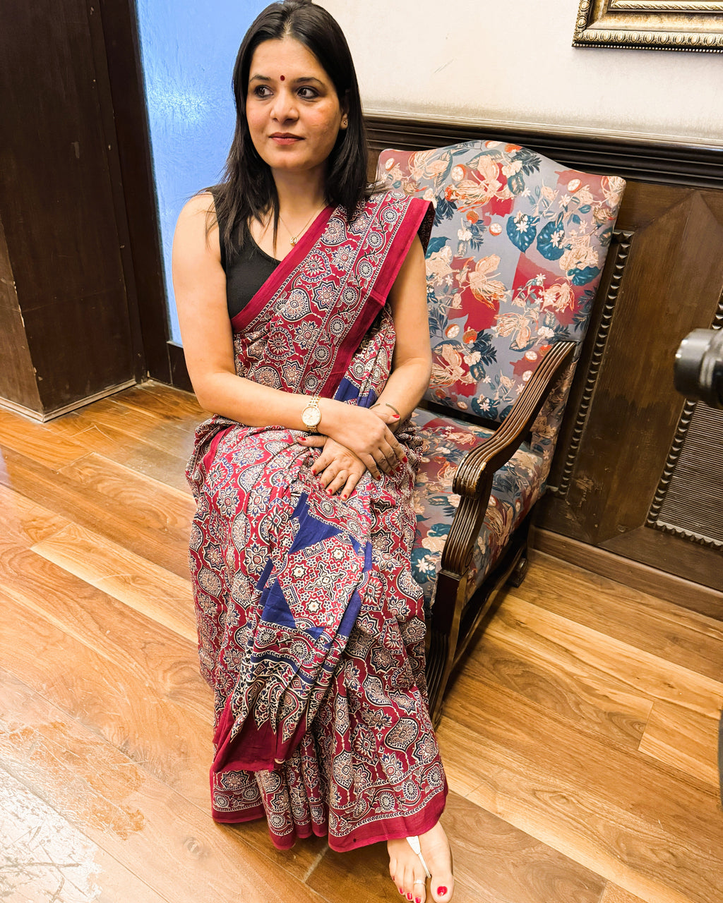Front of maroon and blue Ajrakh print mul cotton saree highlighting overall look and flow
