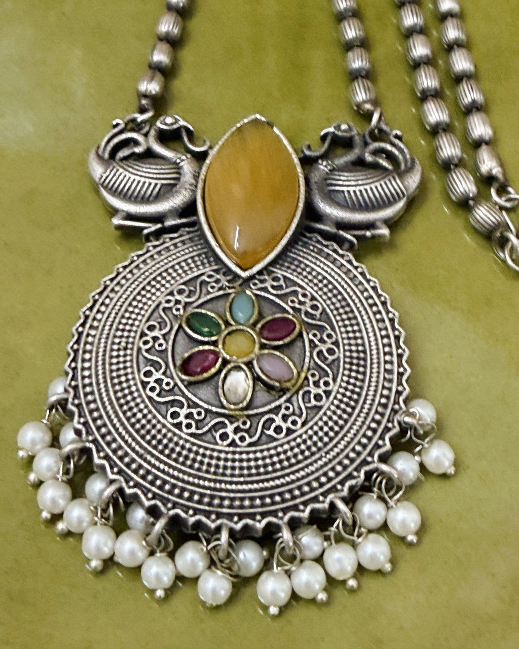 Antique brass peacock motif necklace set with amber stone, multicolour floral pendant and pearl drops full view