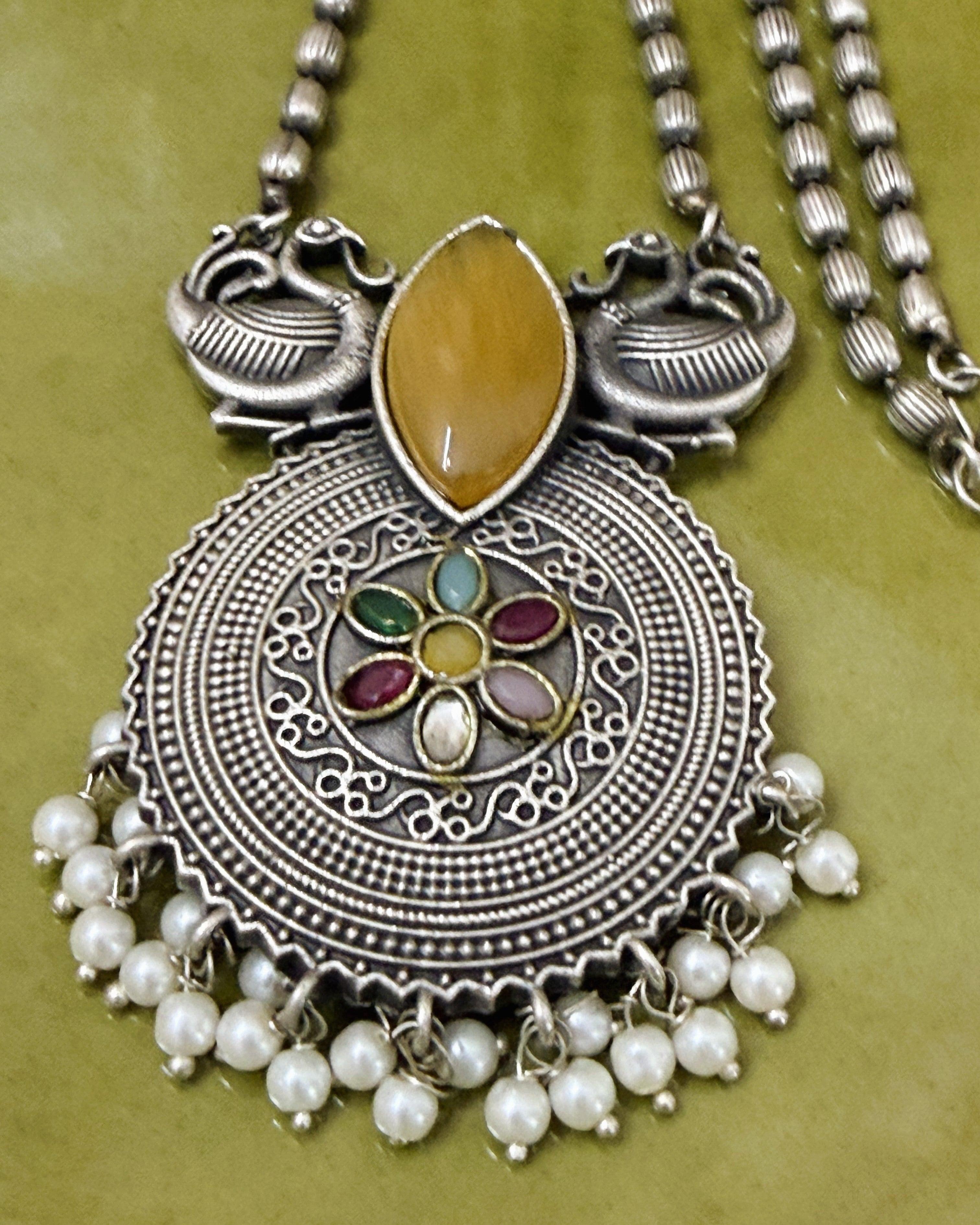 Antique brass peacock motif necklace set with amber stone, multicolour floral pendant and pearl drops full view