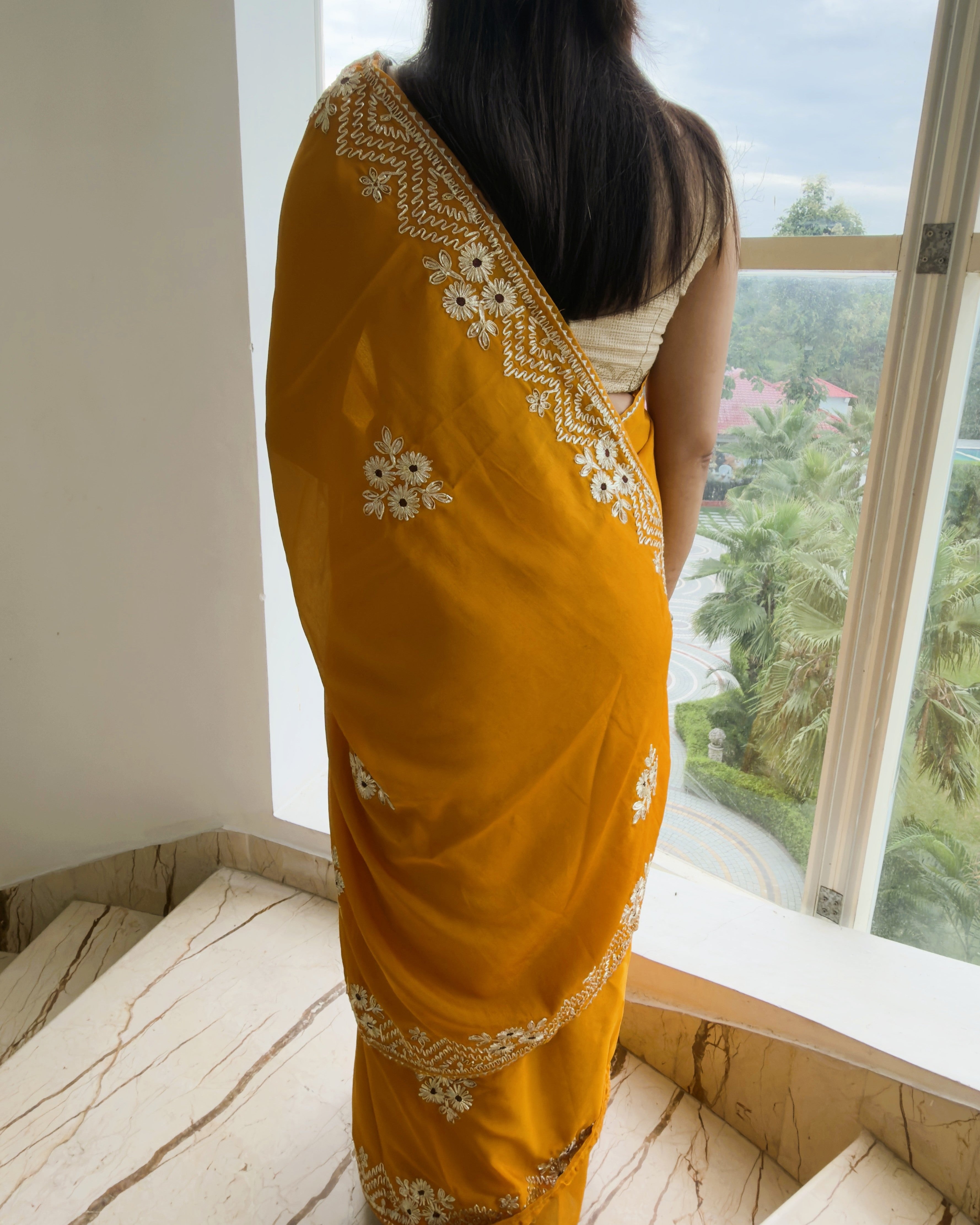 mustard yellow vichitra silk saree back view with silver gotta patti detailing