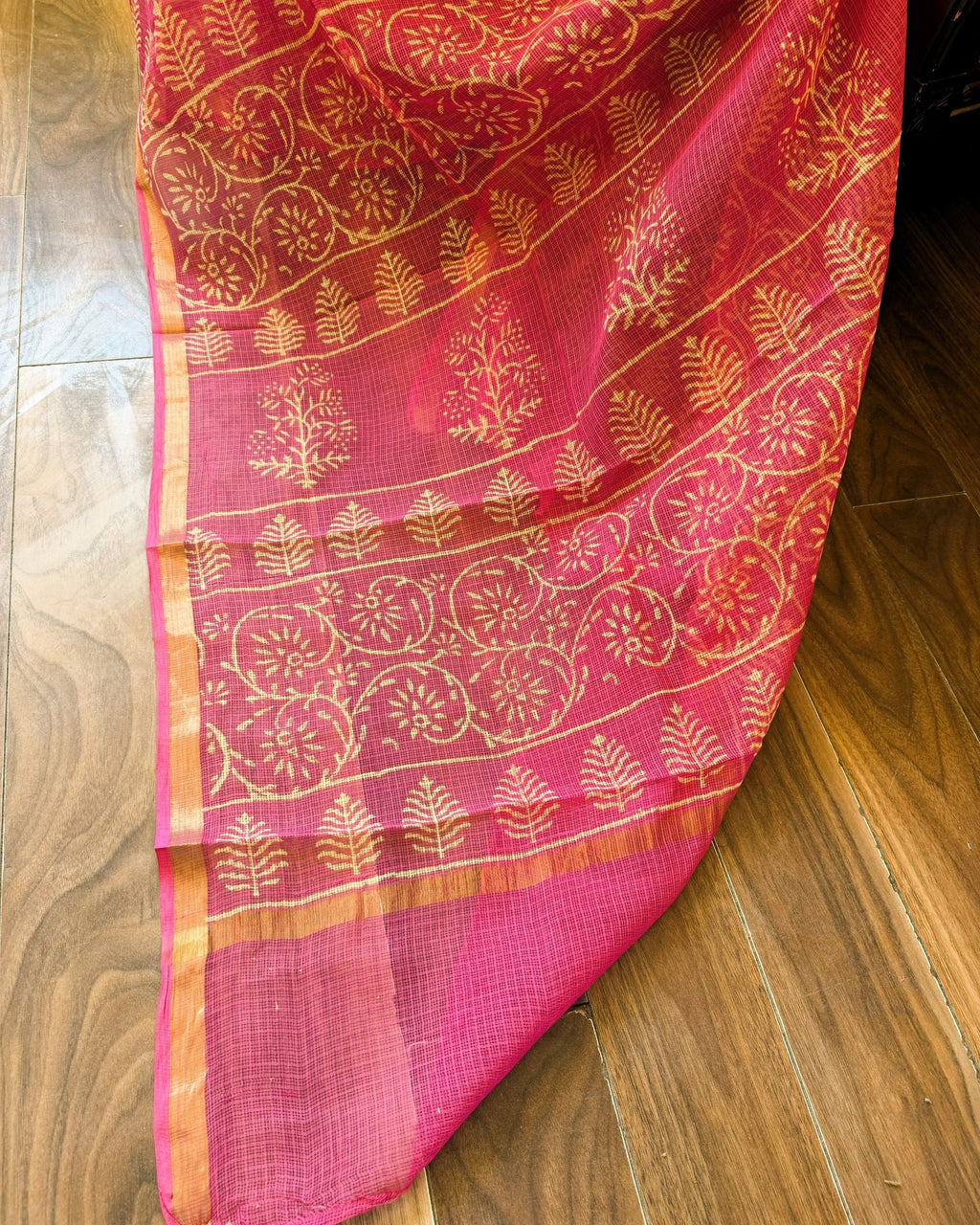Close-up of pink and beige leaf motif handblock print Kota Doriya saree showing intricate patterns and sheer texture