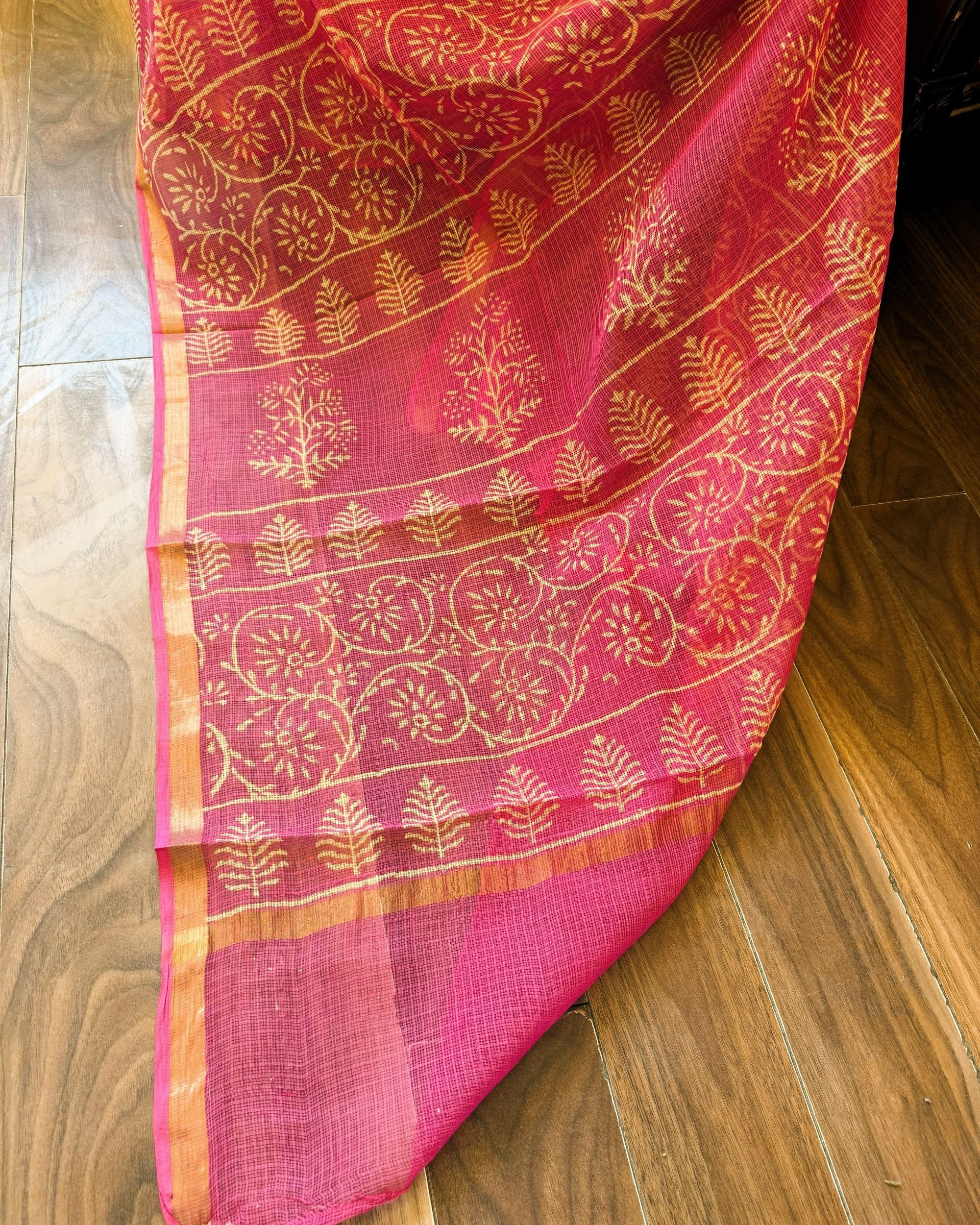 Close-up of pink and beige leaf motif handblock print Kota Doriya saree showing intricate patterns and sheer texture