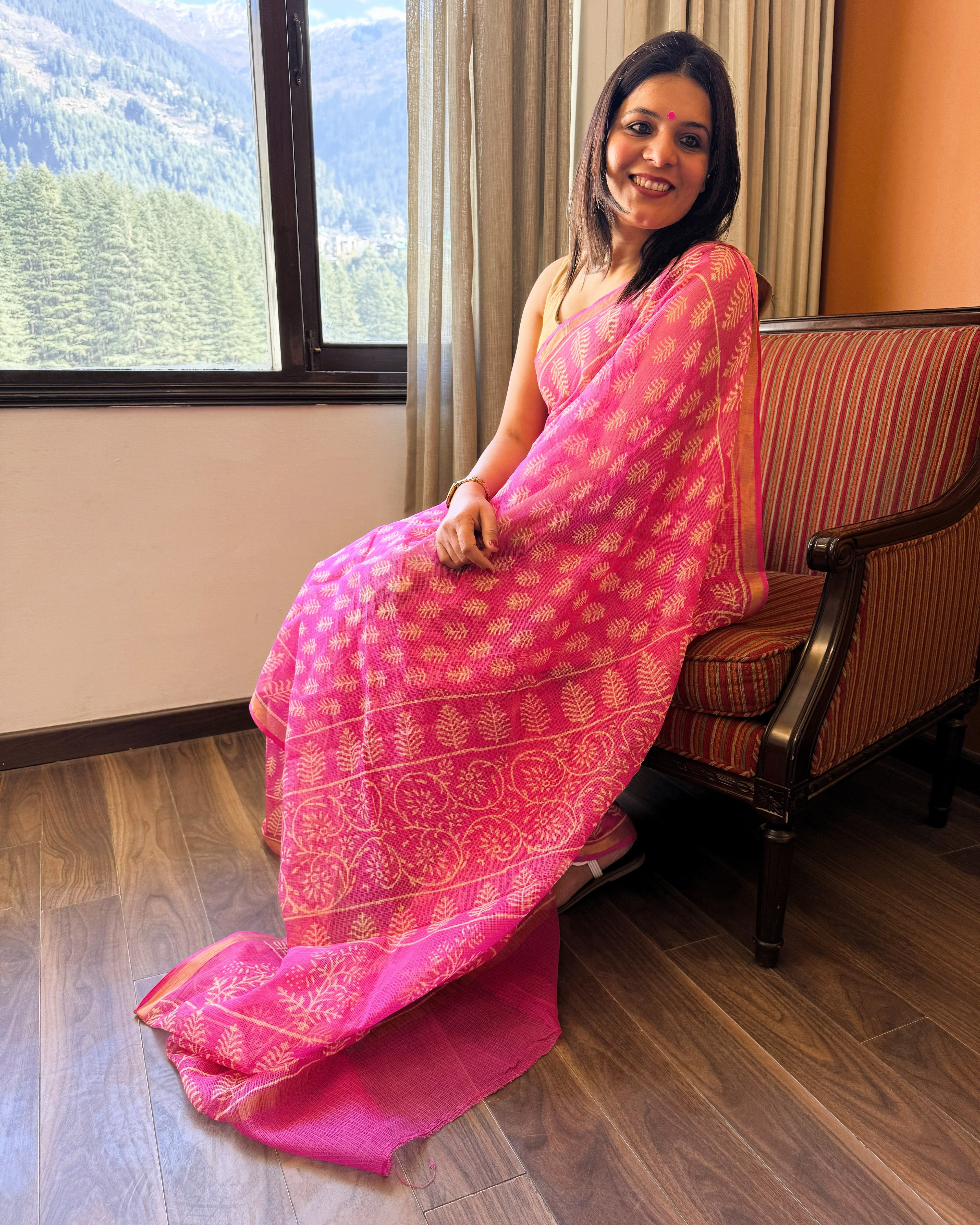 Side view of pink and beige leaf motif handblock print Kota Doriya saree displaying soft drape and border detail
