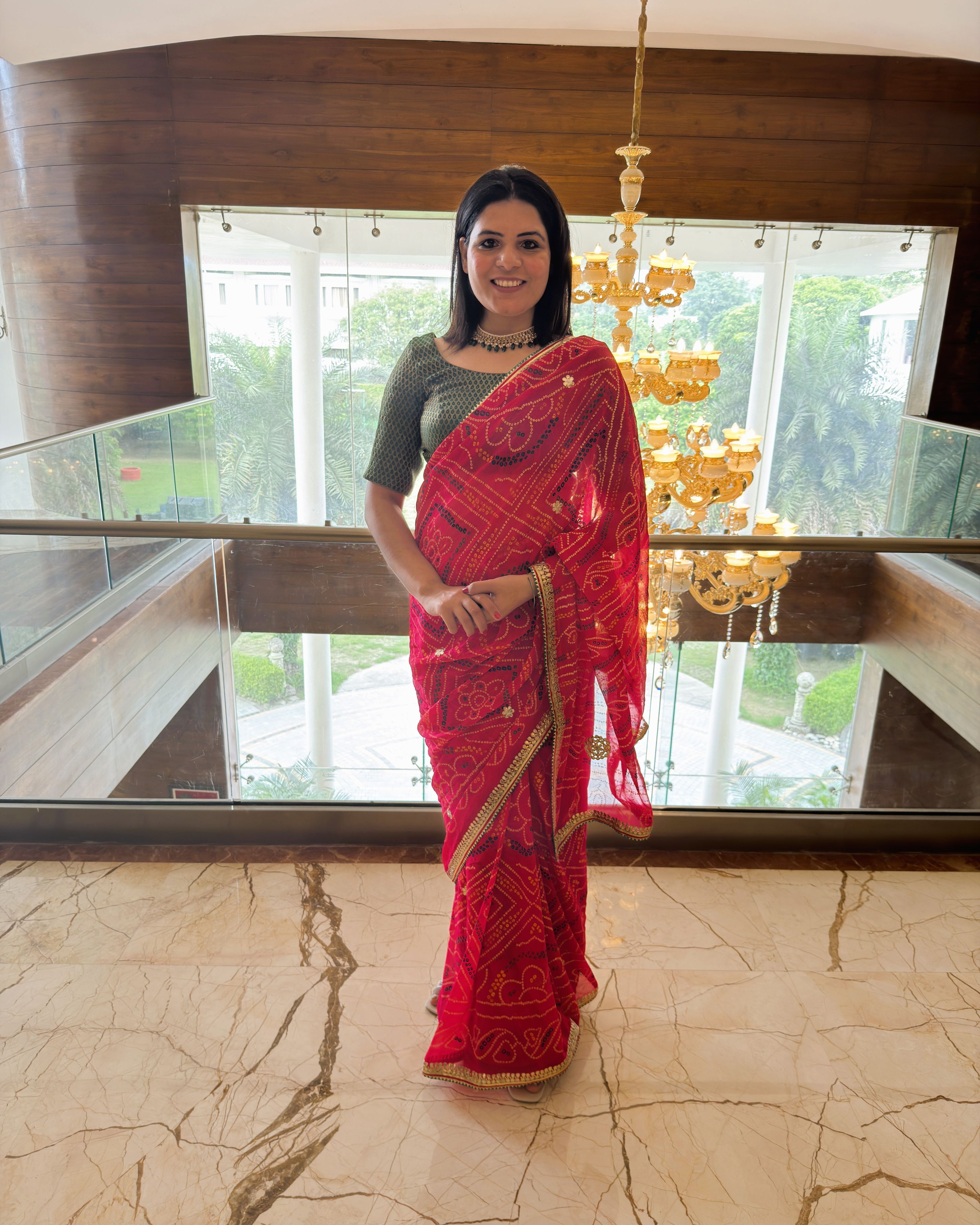 full look of rani pink pure georgette bandhej saree with multicolour print and gotta patti border