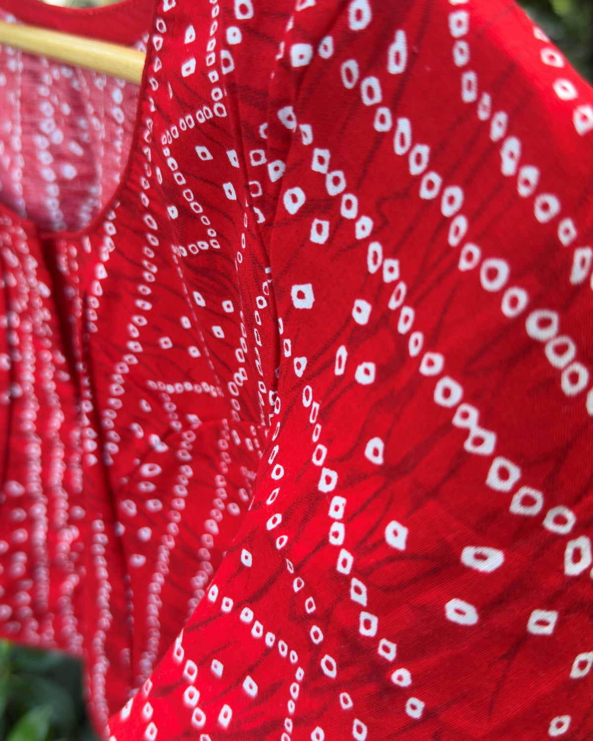 red bandhej blouse with round neckline and short sleeves