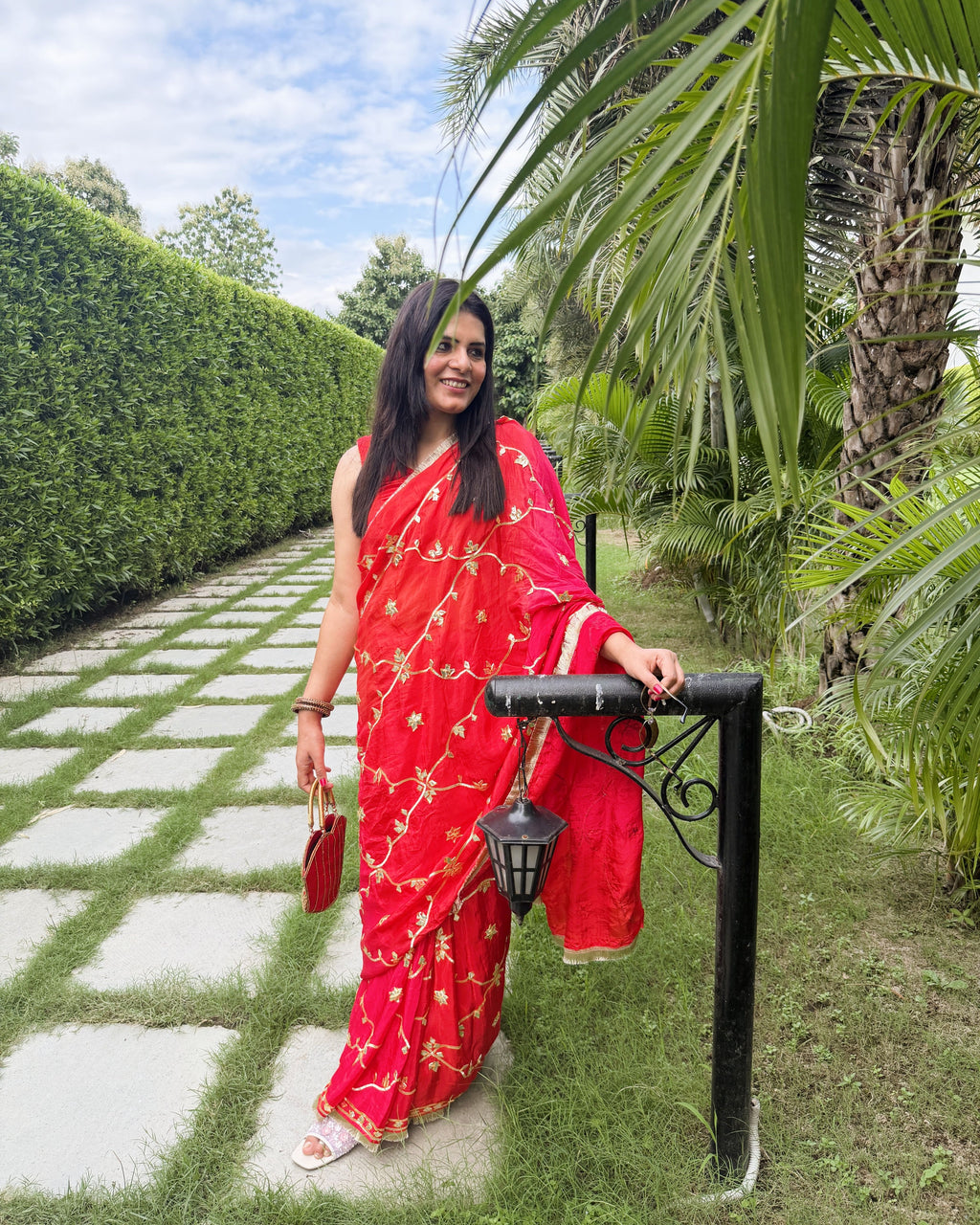 elegant red festive saree with traditional gold gotta patti work and fringe border