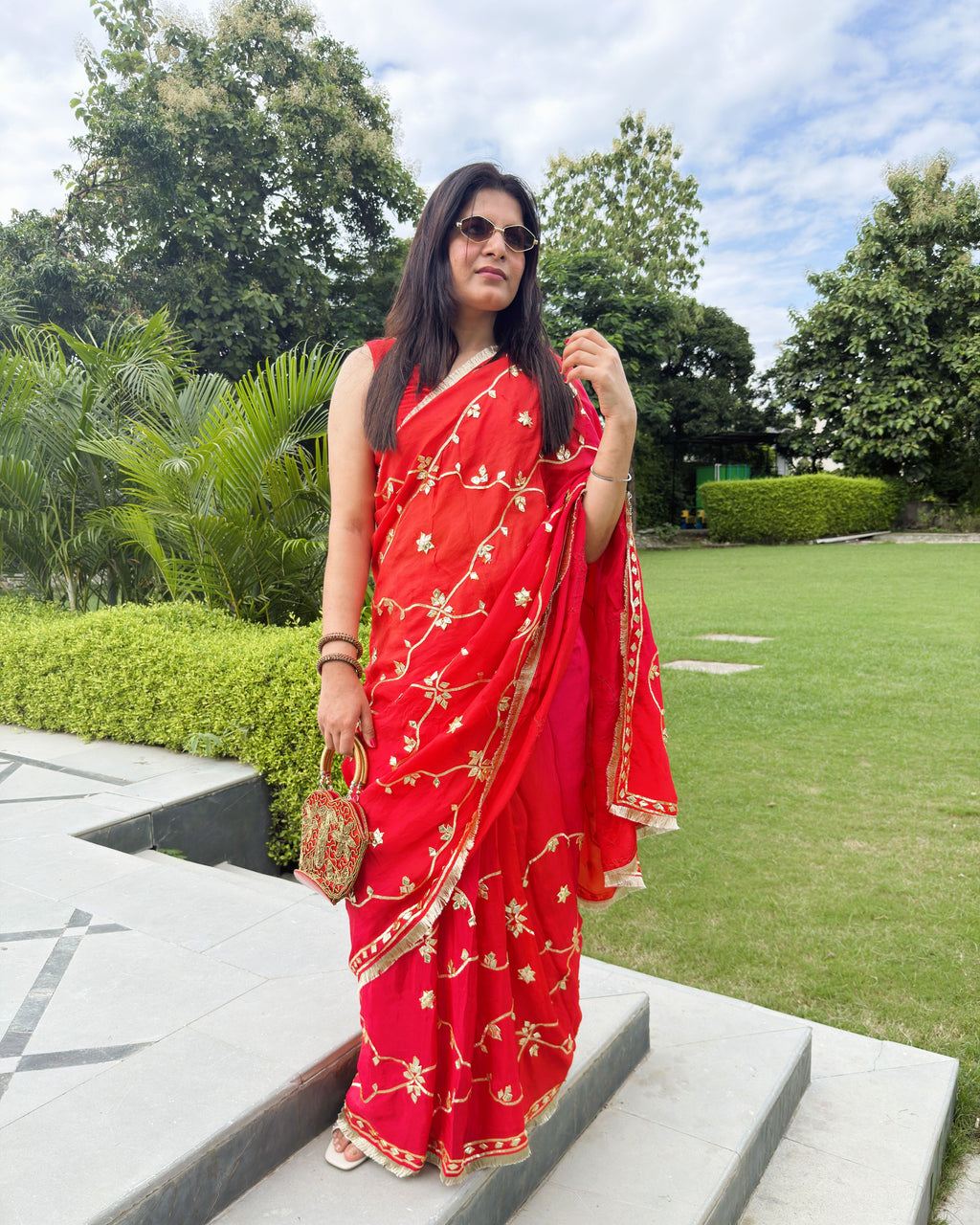 red HO saree with gold gotta patti floral motifs and decorative border