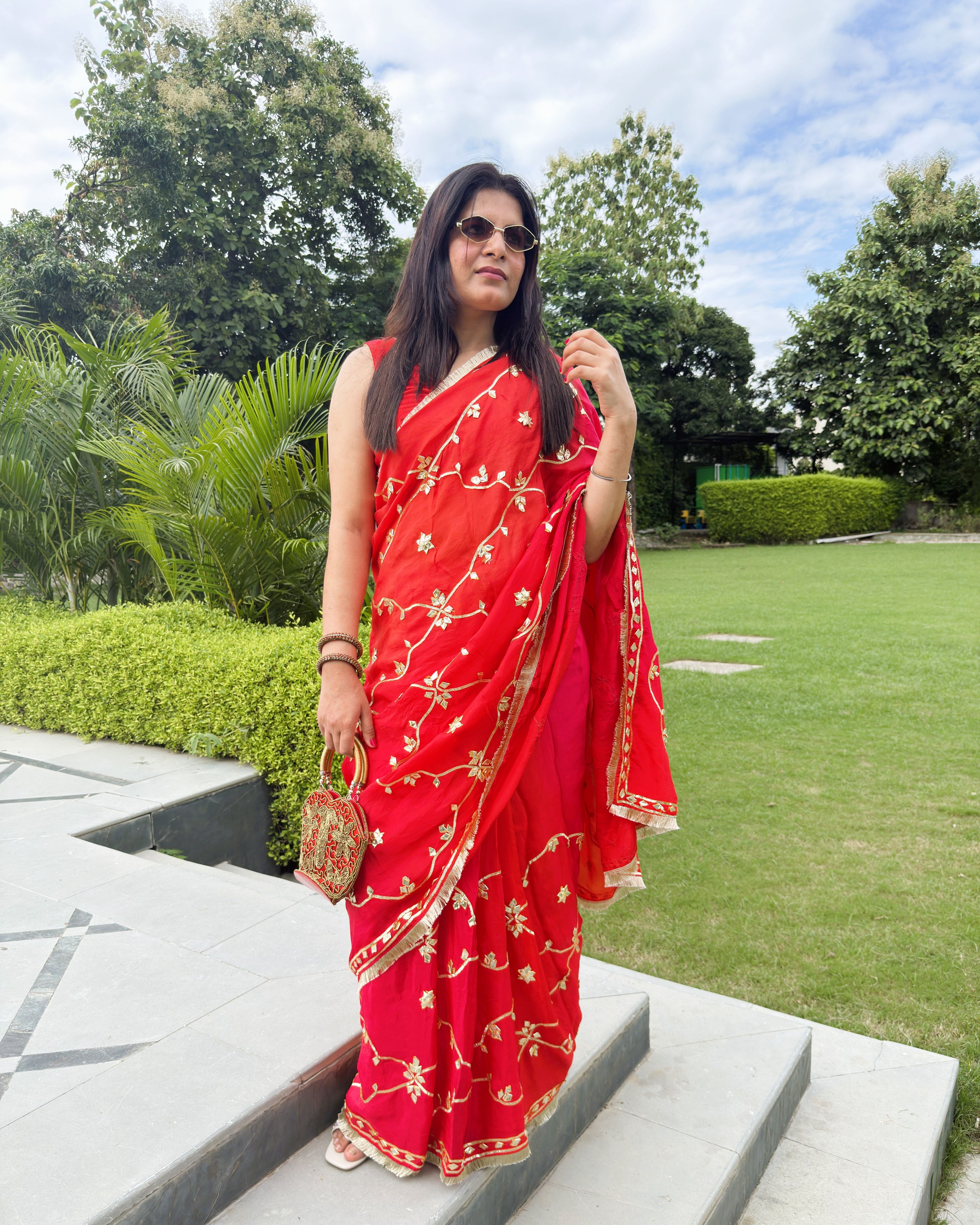 red HO saree with gold gotta patti floral motifs and decorative border