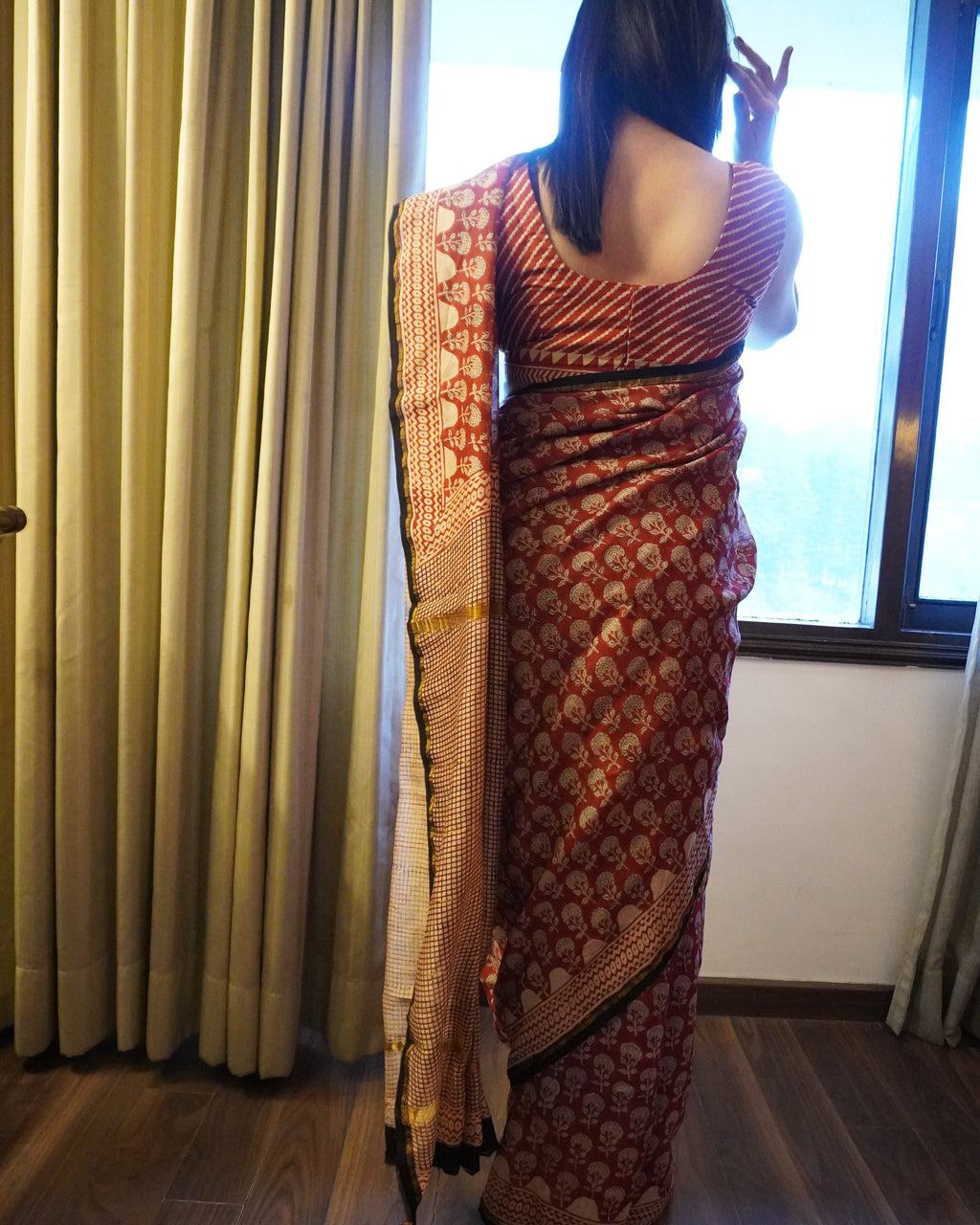 Back view of rustic maroon Chanderi silk handblock Bagru print saree showcasing pallu and graceful fall