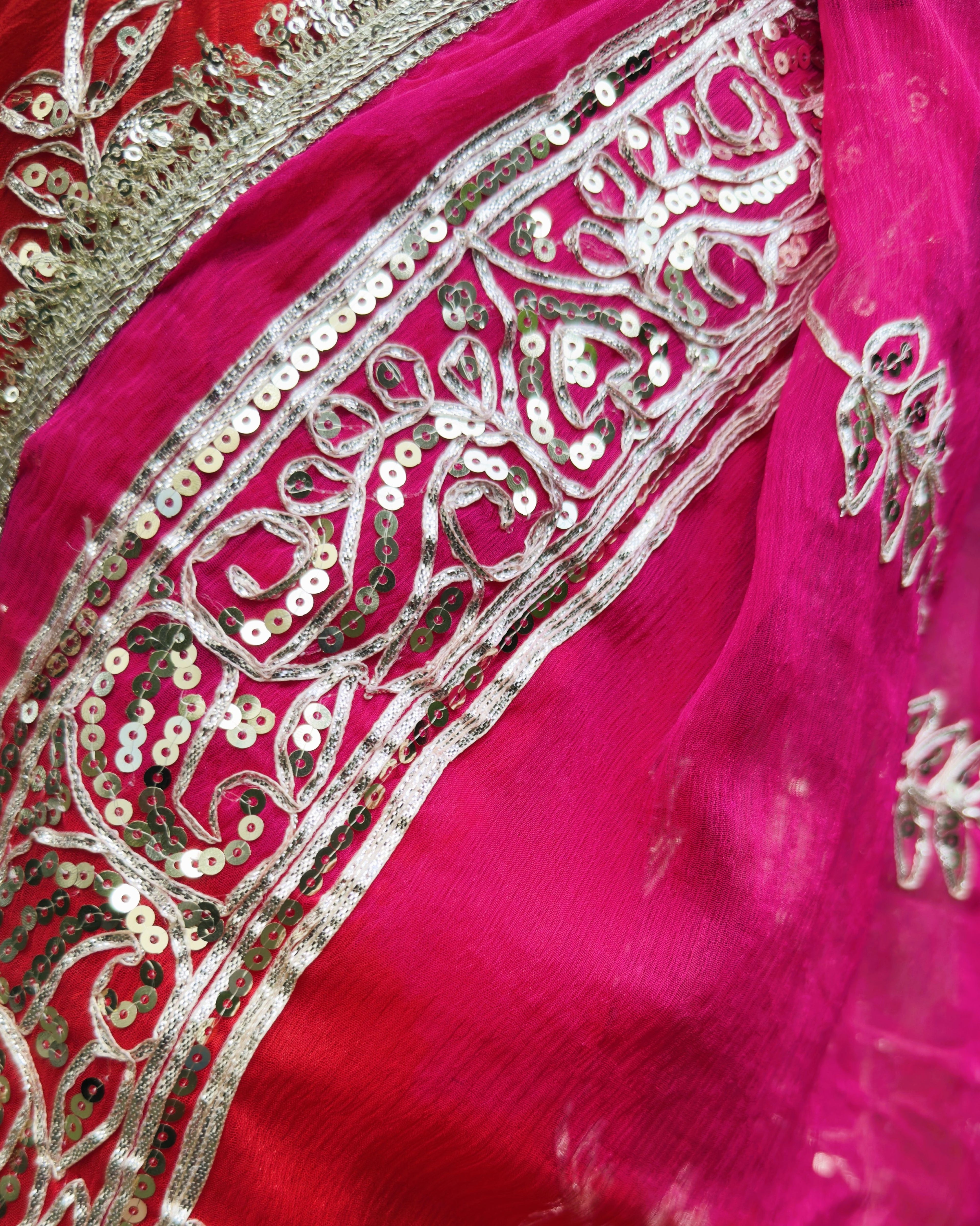 close up of silver gotta patti and sequin work on hot pink chiffon saree