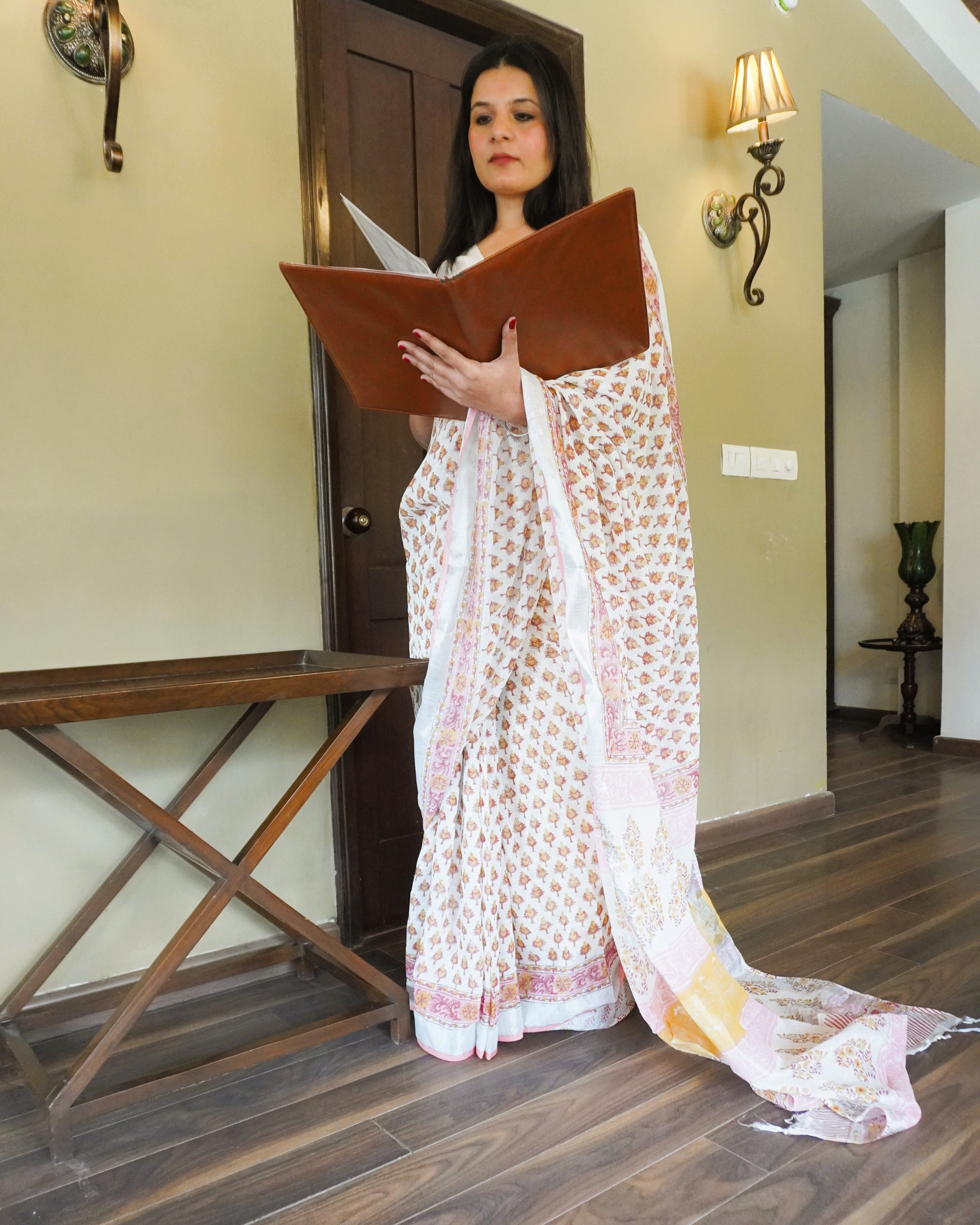 Front view of white multicolour handblock leaf motif print pure linen saree showcasing full drape
