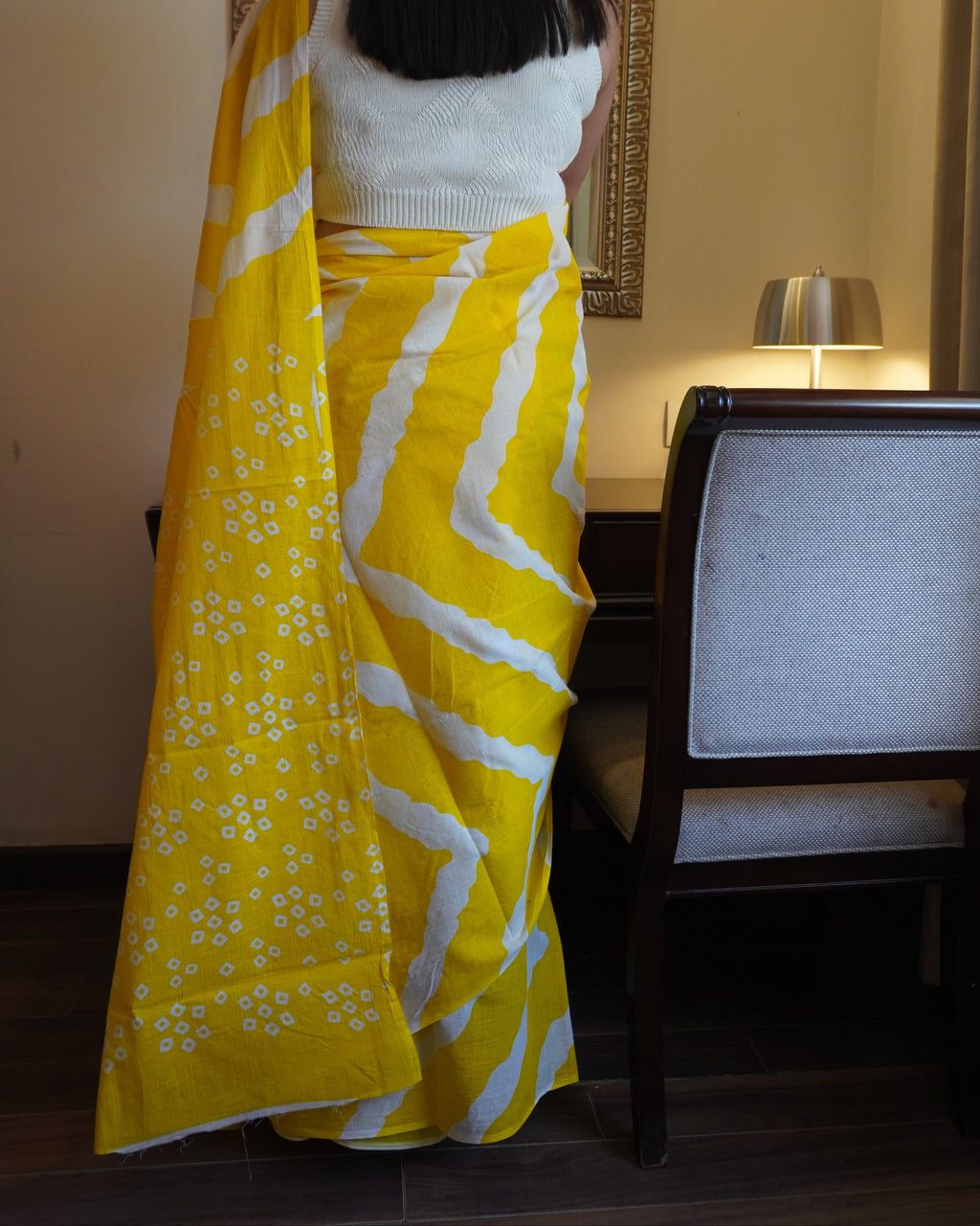 Back view of yellow and white Leheriya cotton saree showcasing pallu design and graceful fall