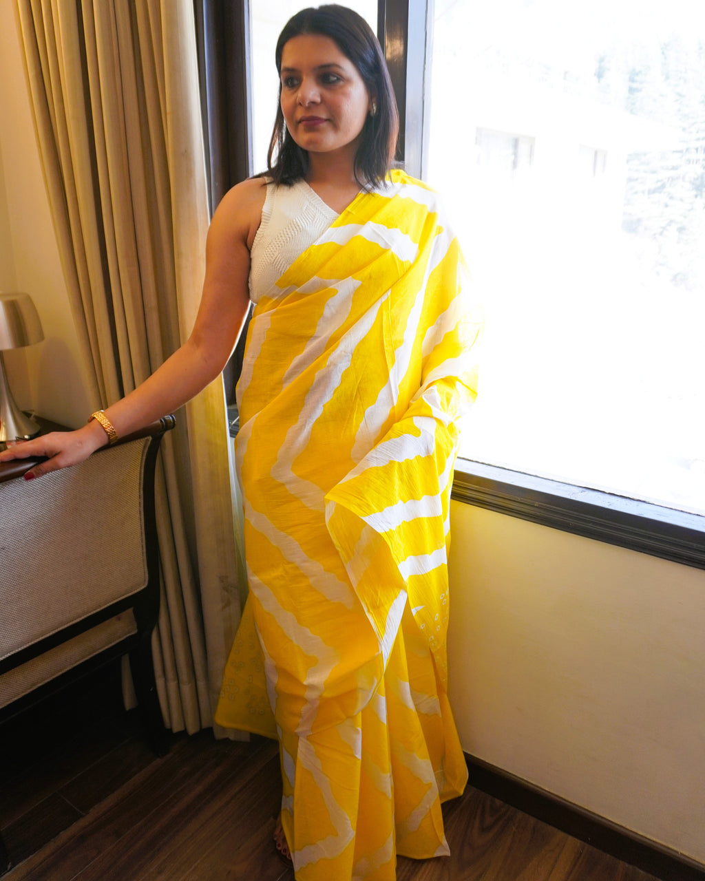 Alternate front view of yellow and white Leheriya cotton saree highlighting overall flow and vibrant look