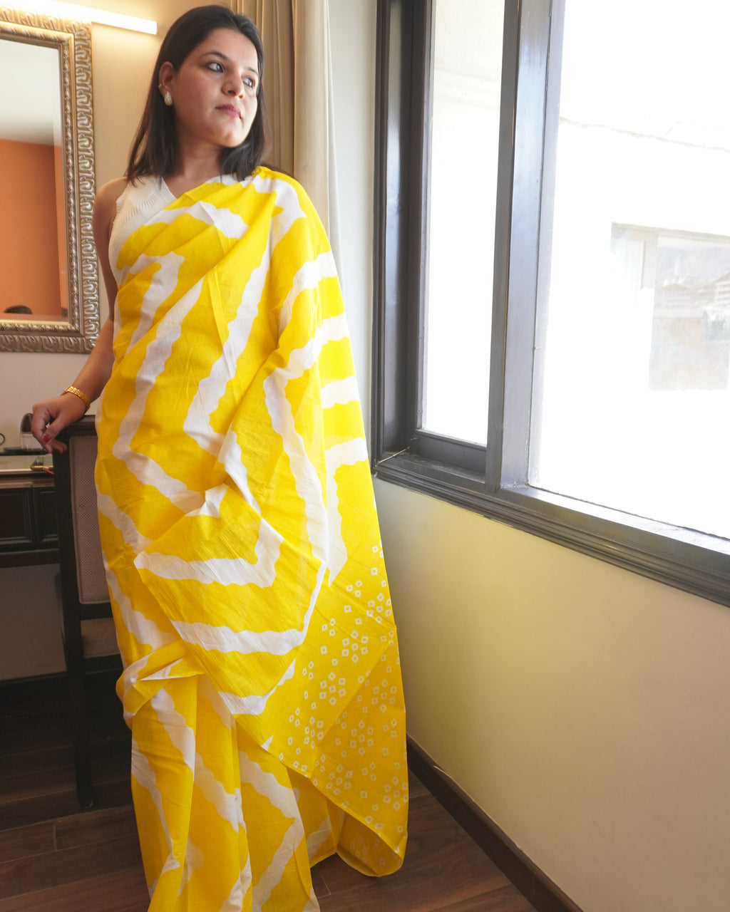 Front view of yellow and white Leheriya cotton saree showcasing full drape and traditional wave pattern