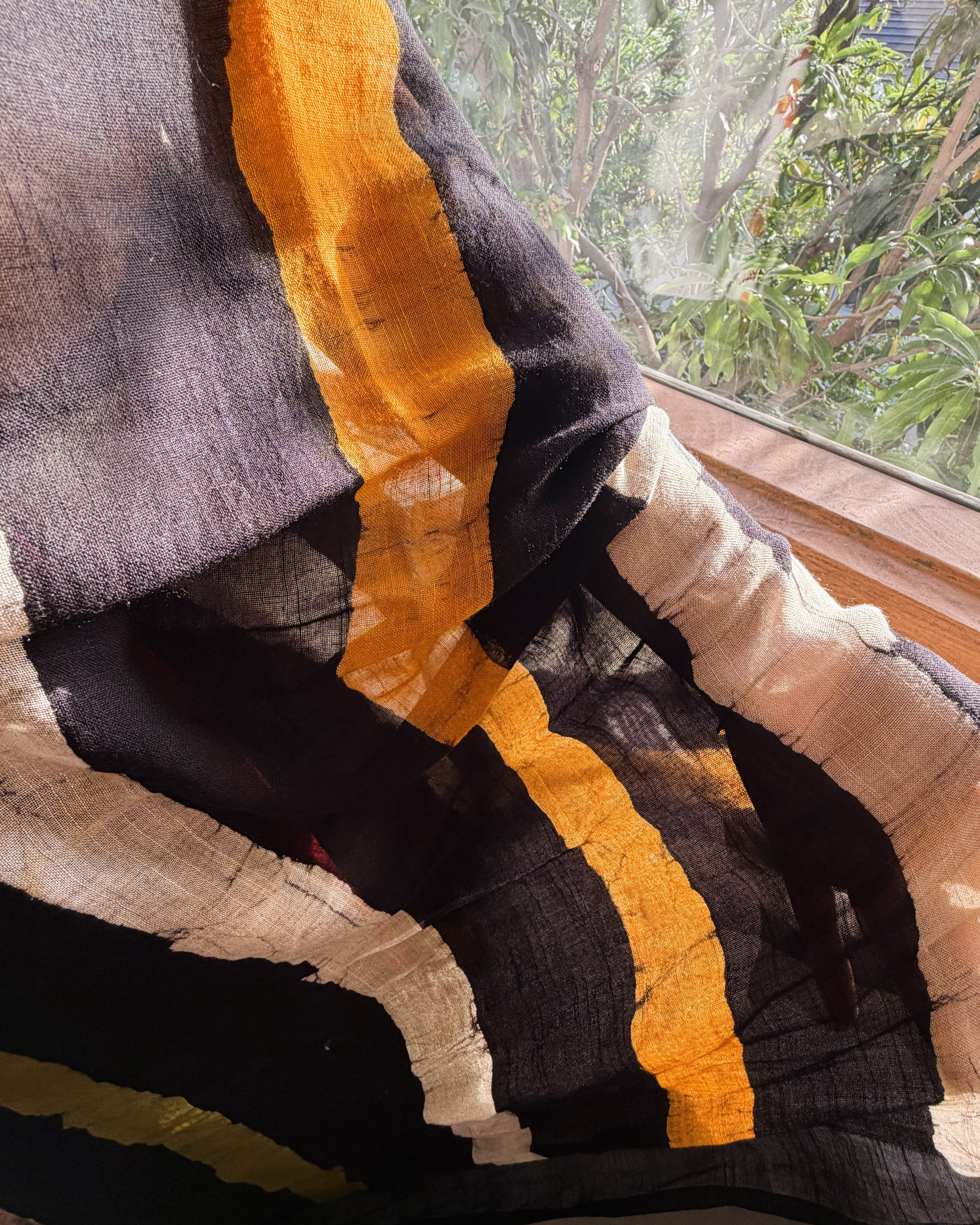 close up batik print design on black linen saree