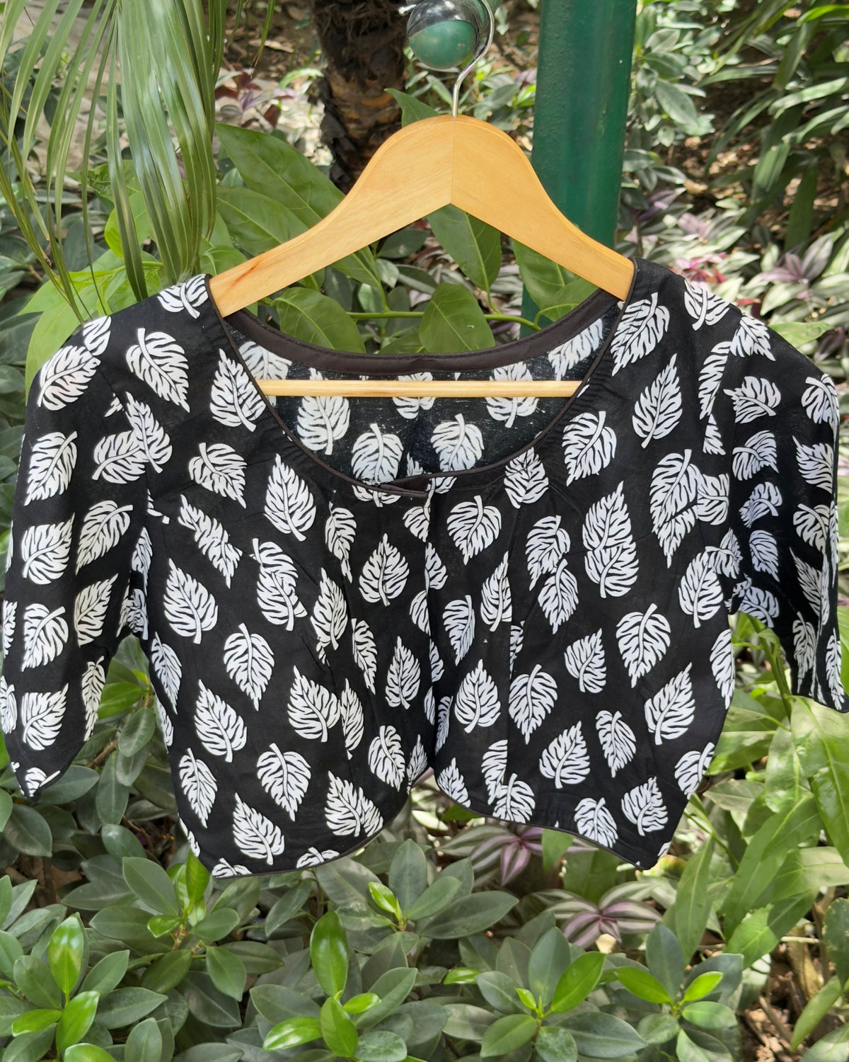 Black cotton blouse with white leaf print motifs, front view
