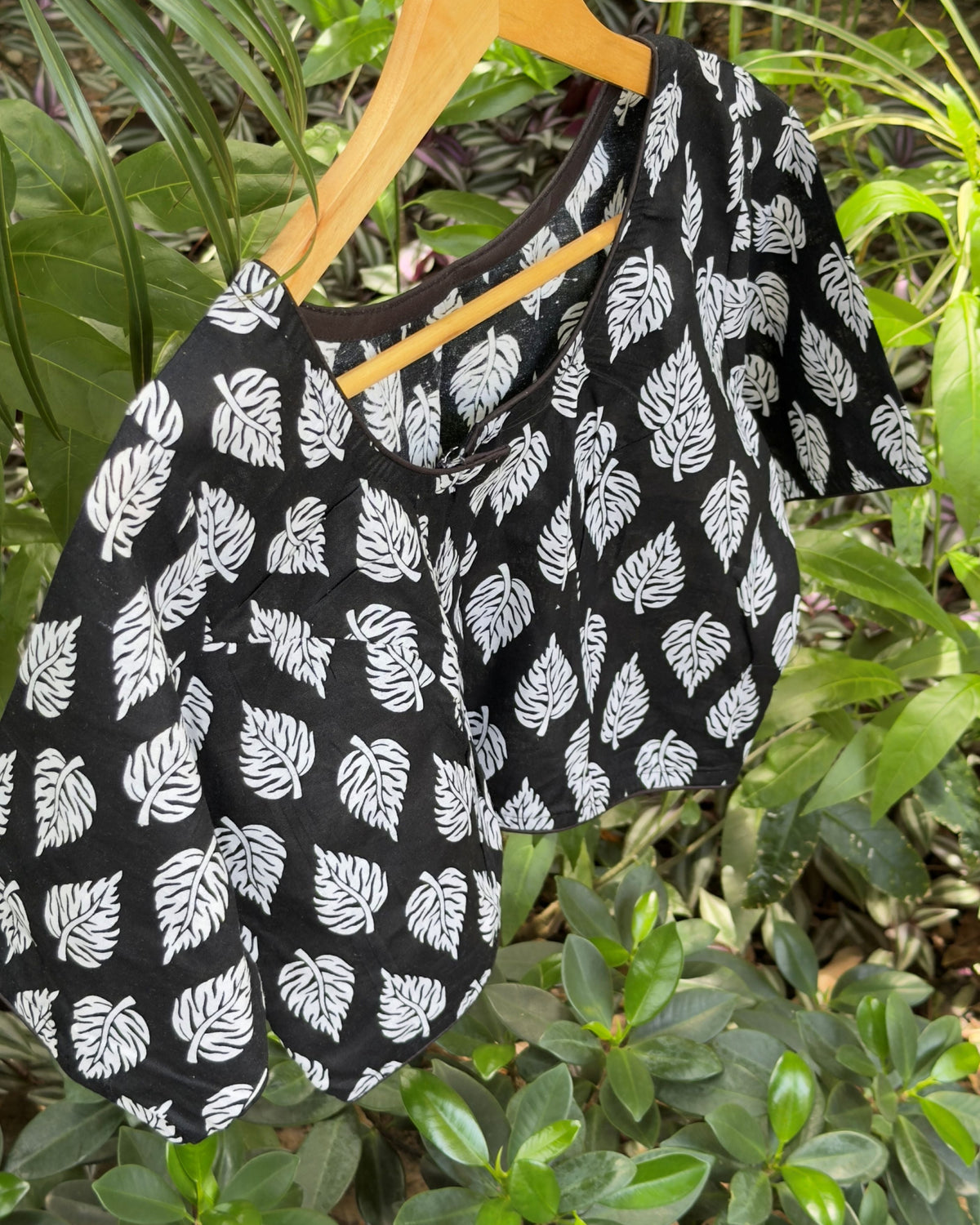 Black cotton leaf print blouse with white botanical motifs, back view