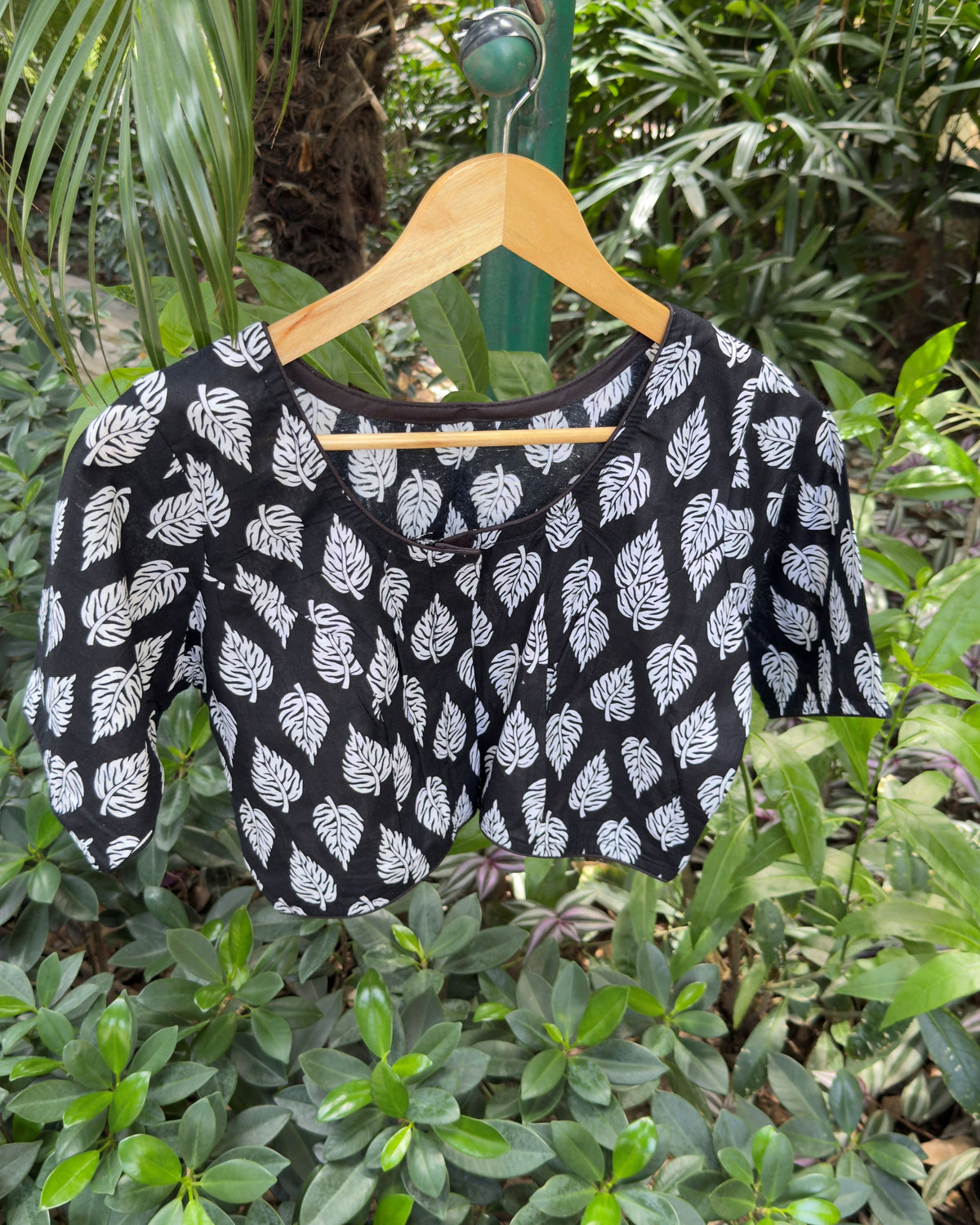 Black ready-to-wear cotton blouse featuring an all-over white leaf print