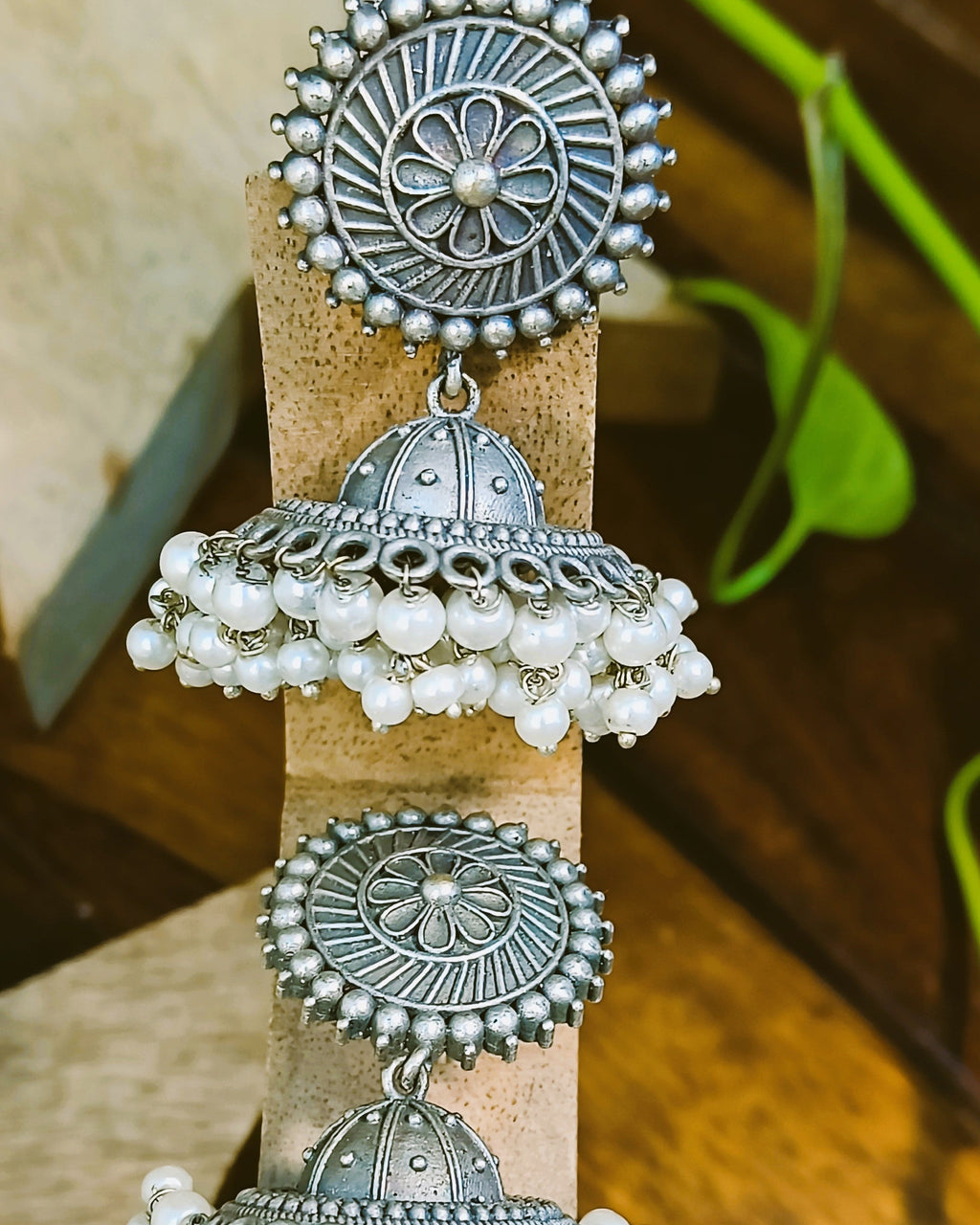 Detailed view of the domed jhumka bell with bead-dot pattern and scalloped loop base of the Pushpa antique oxidised silver earring, traditional and modern look