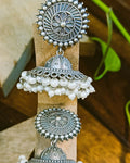 Detailed view of the domed jhumka bell with bead-dot pattern and scalloped loop base of the Pushpa antique oxidised silver earring, traditional and modern look