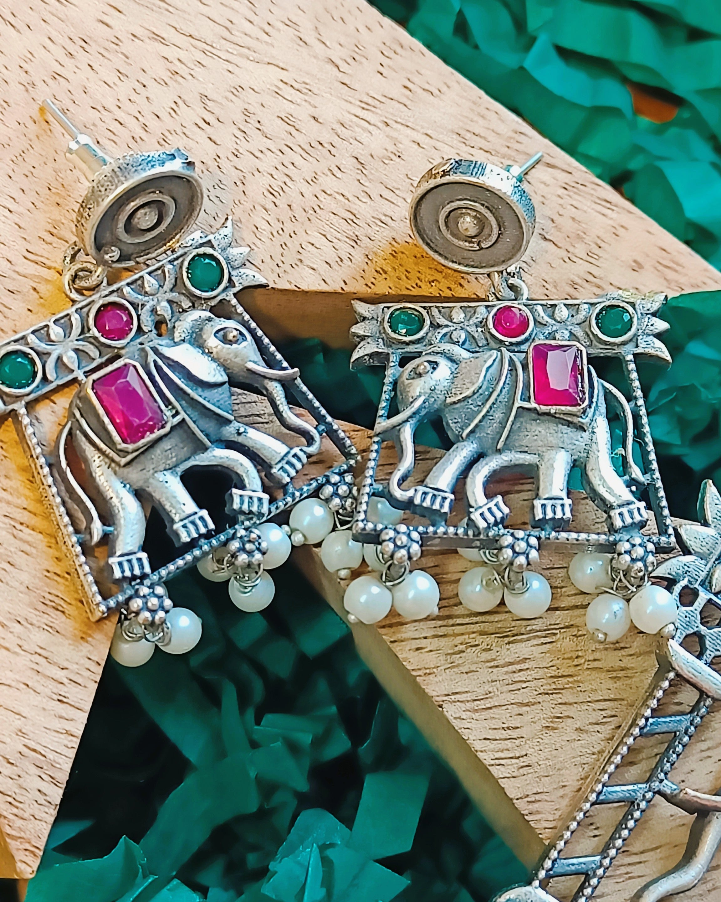 Oxidised silver elephant drop earrings with ruby-red and emerald-green stones and delicate pearl drops