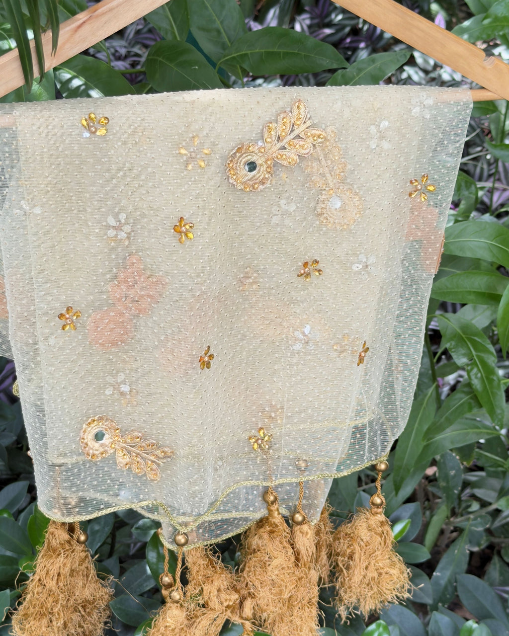 Close-up of golden tassels and braided border on net dupatta