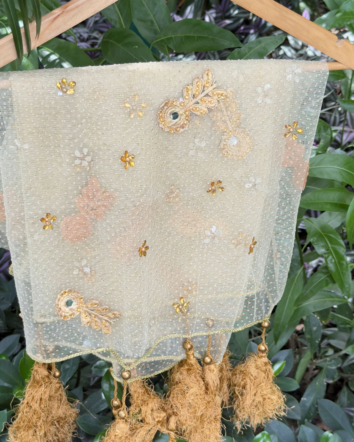 Close-up of golden tassels and braided border on net dupatta