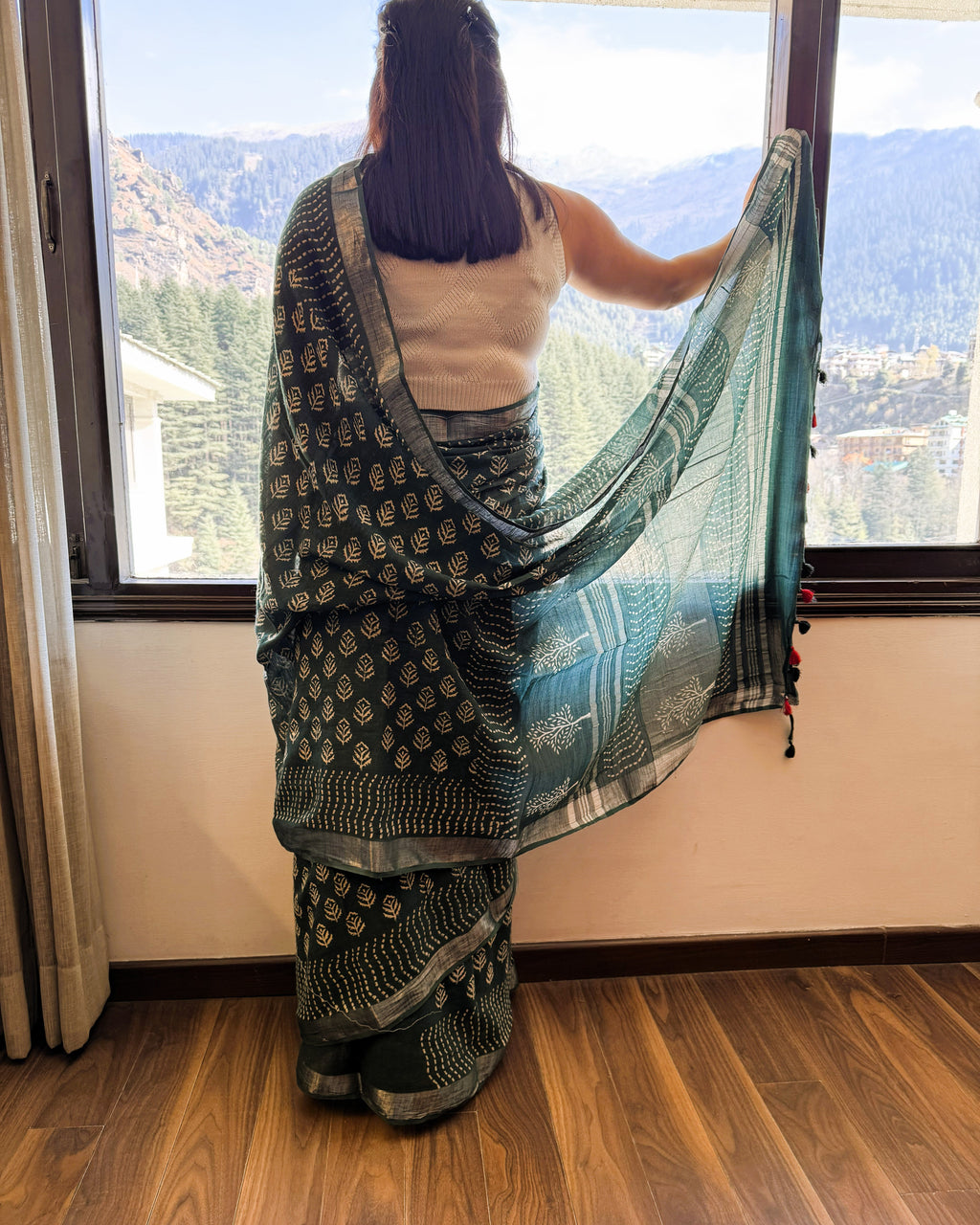 Back view of green and beige hand block leaf print linen saree