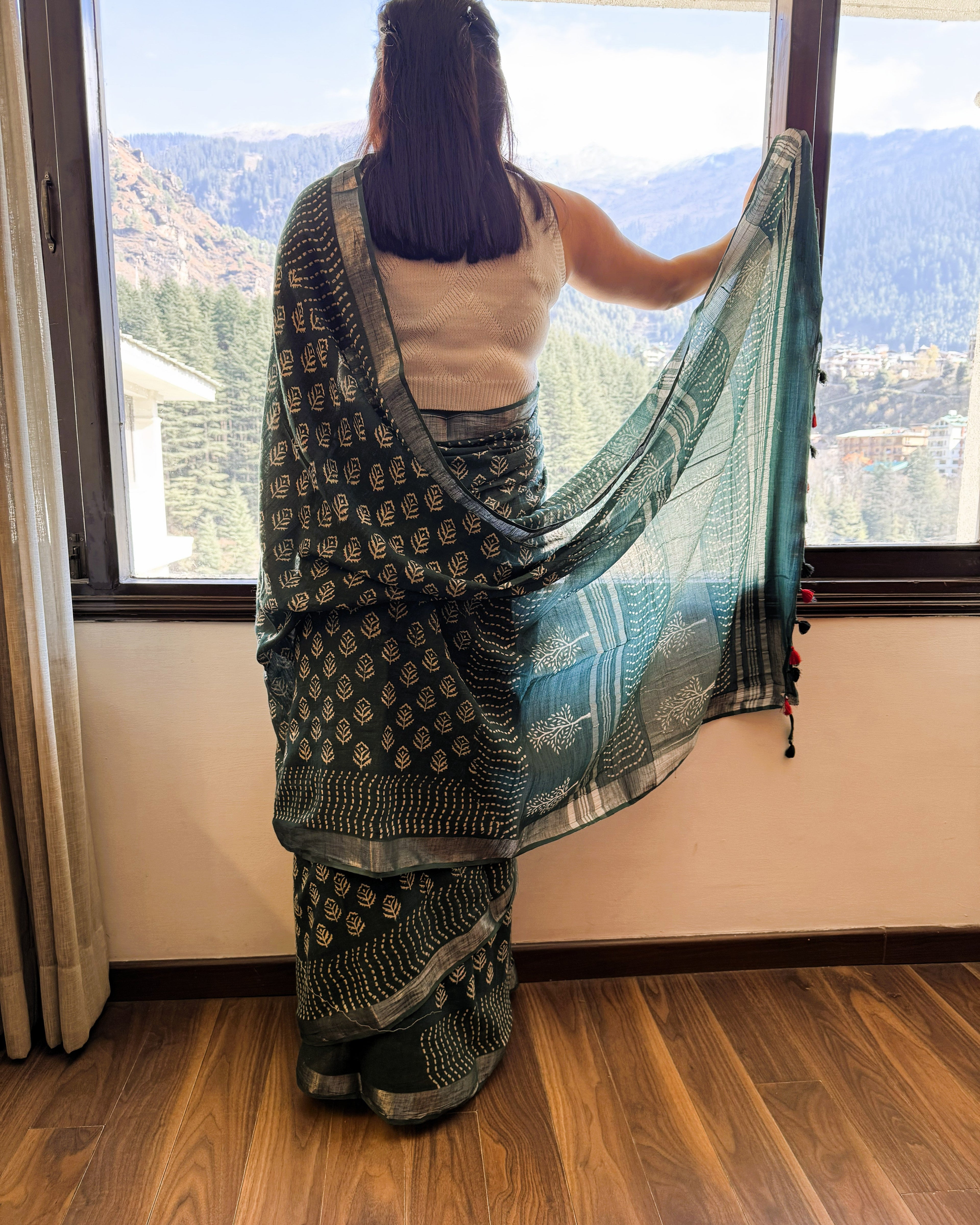 Back view of green and beige hand block leaf print linen saree