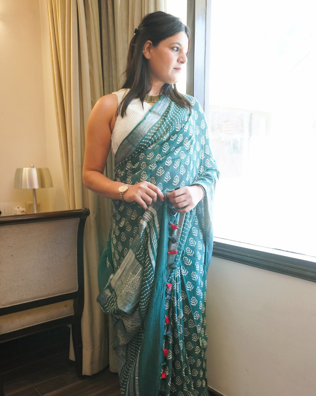 Side view of green and beige leaf print pure linen saree