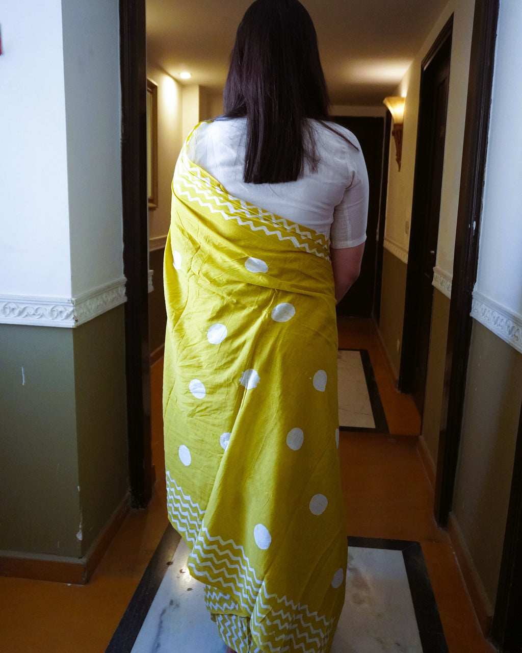 Back view of green cotton saree with white polka dot design