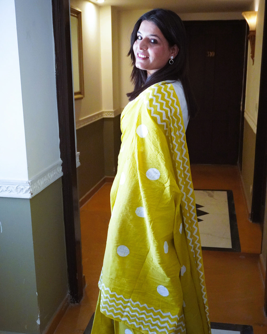 Side view of green cotton saree with white polka dots