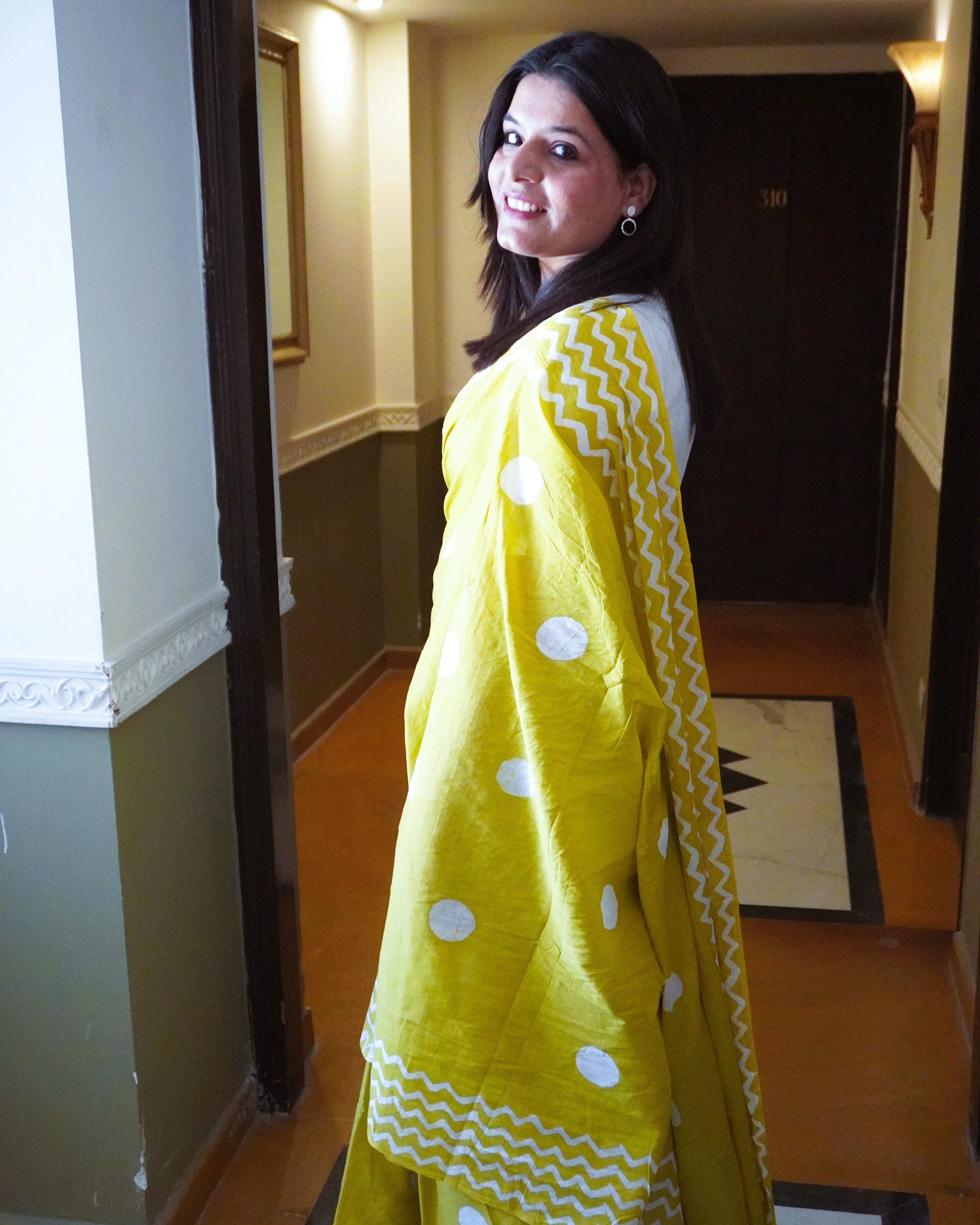Side view of green cotton saree with white polka dots