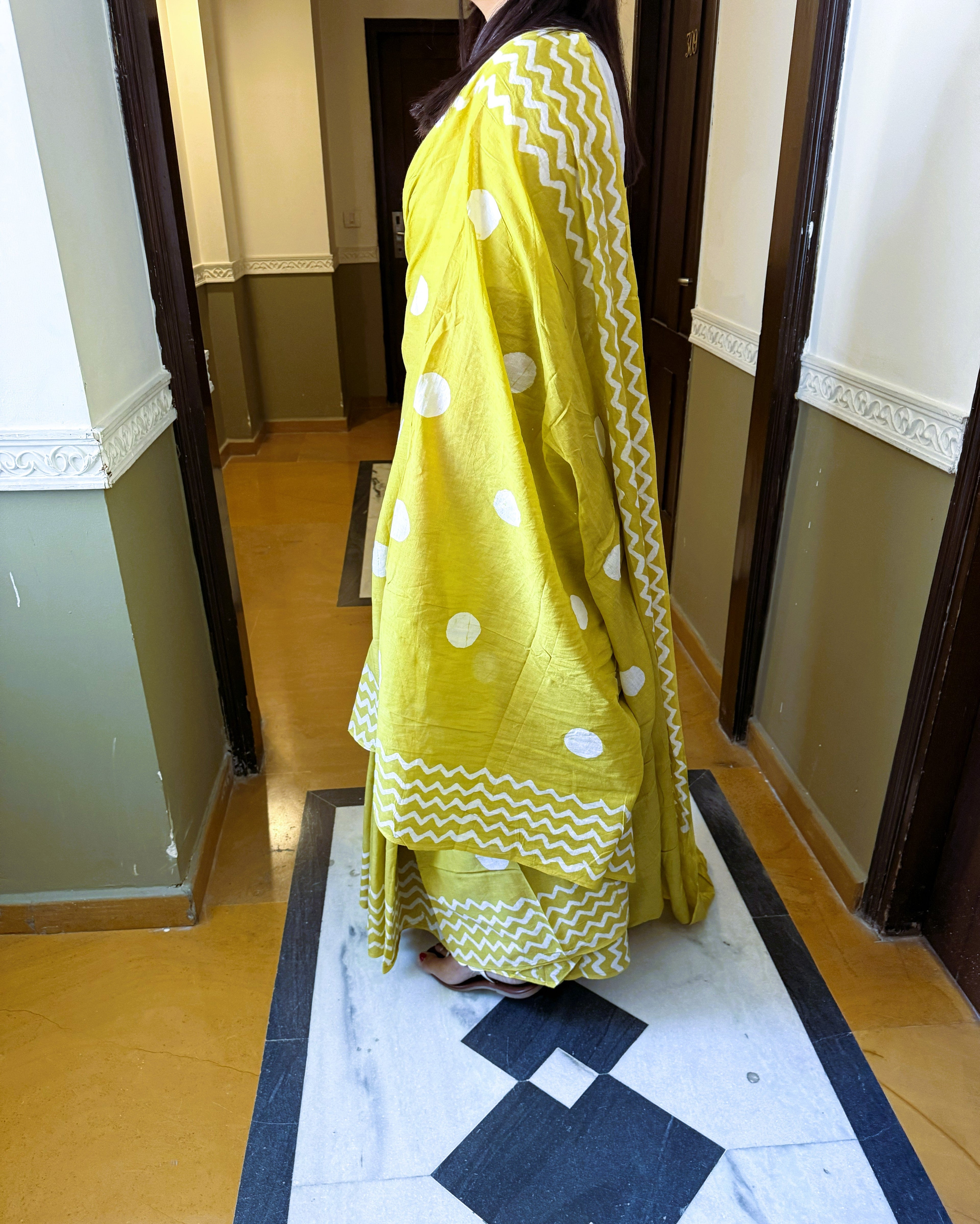 Side view of green cotton saree with white polka dots