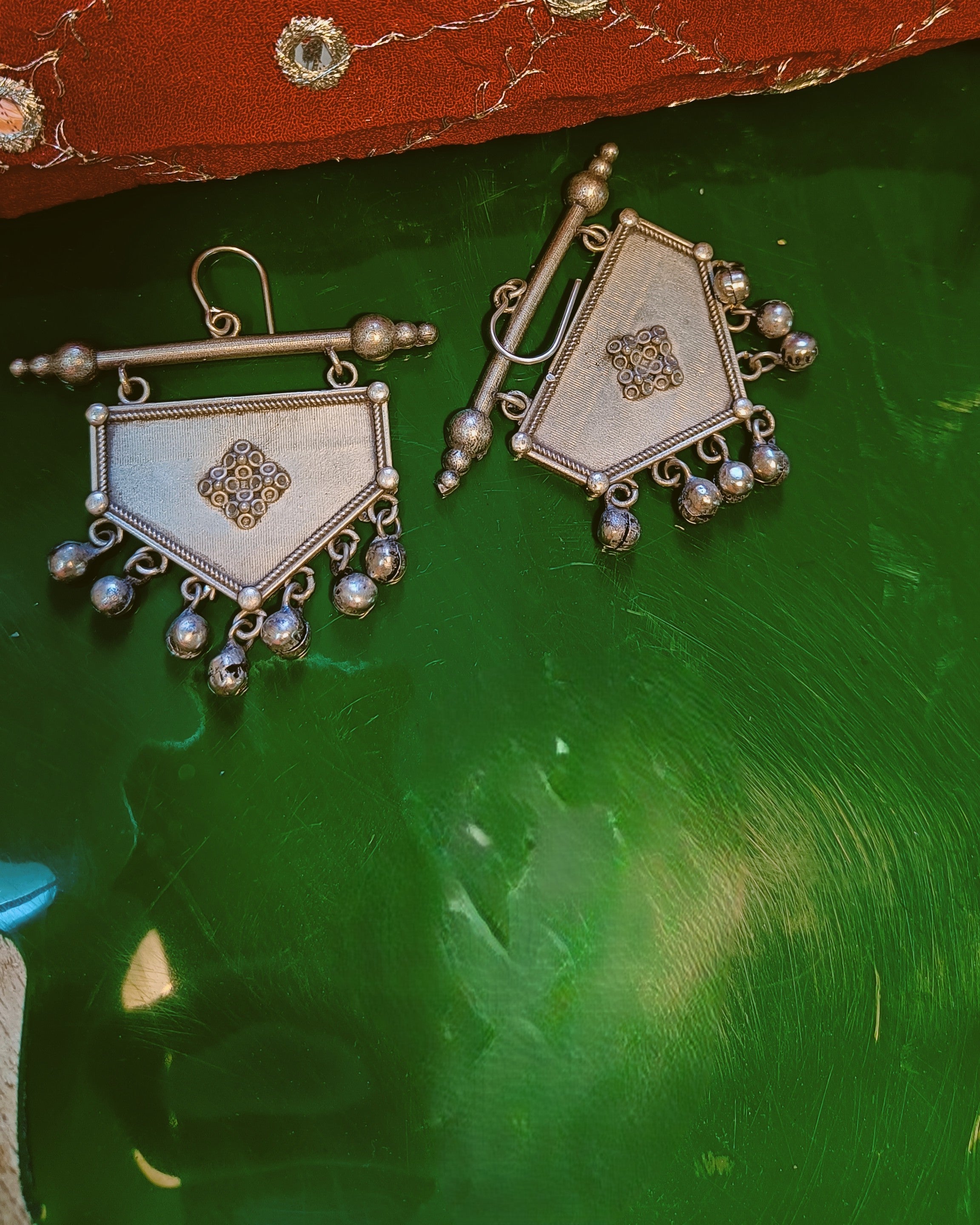 Khanjar shield drop earrings in antique oxidised silver styled with ethnic wear showcasing the tribal geometric silhouette and ghungroo drops