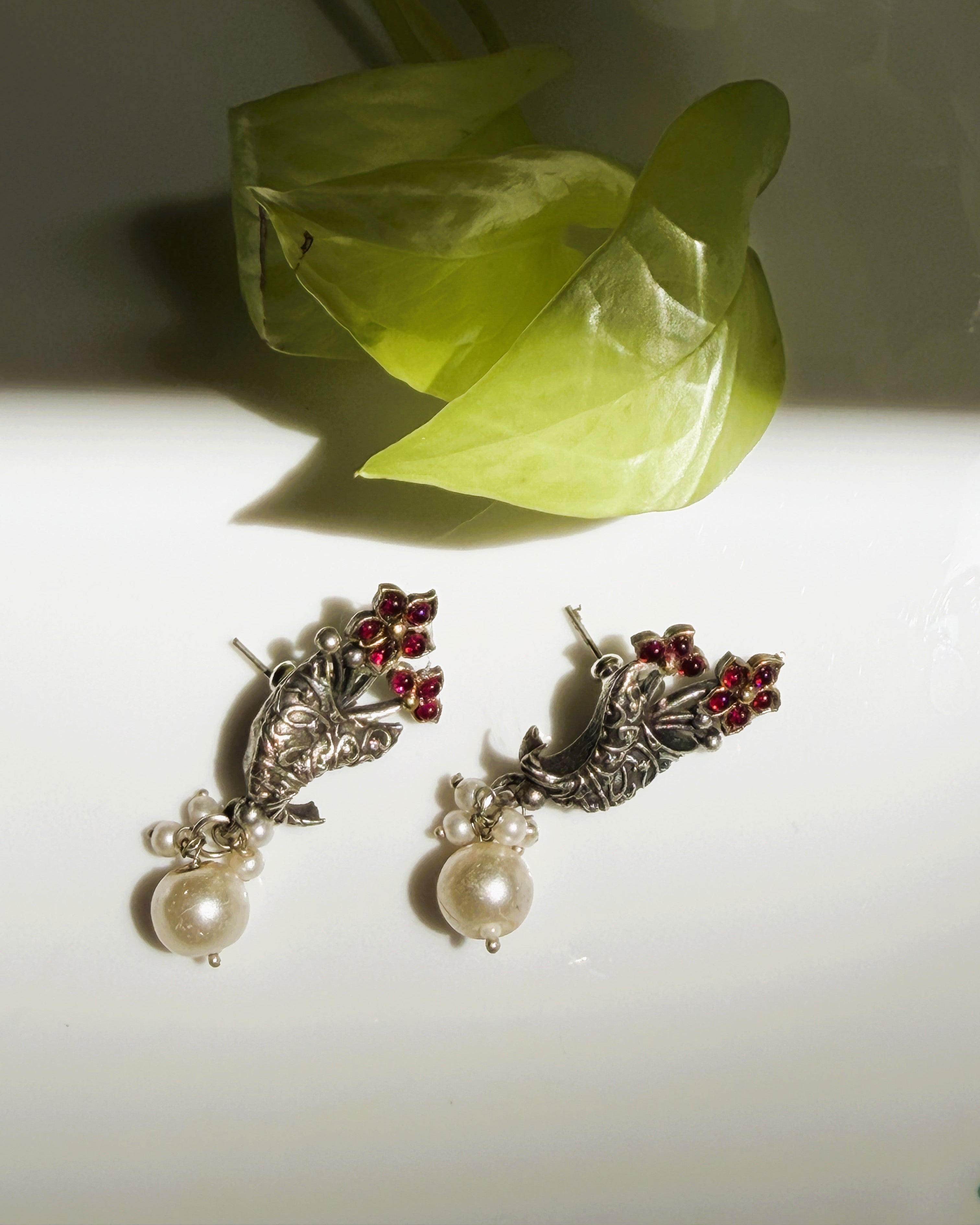Matching oxidised earrings with red stones and pearl drops
