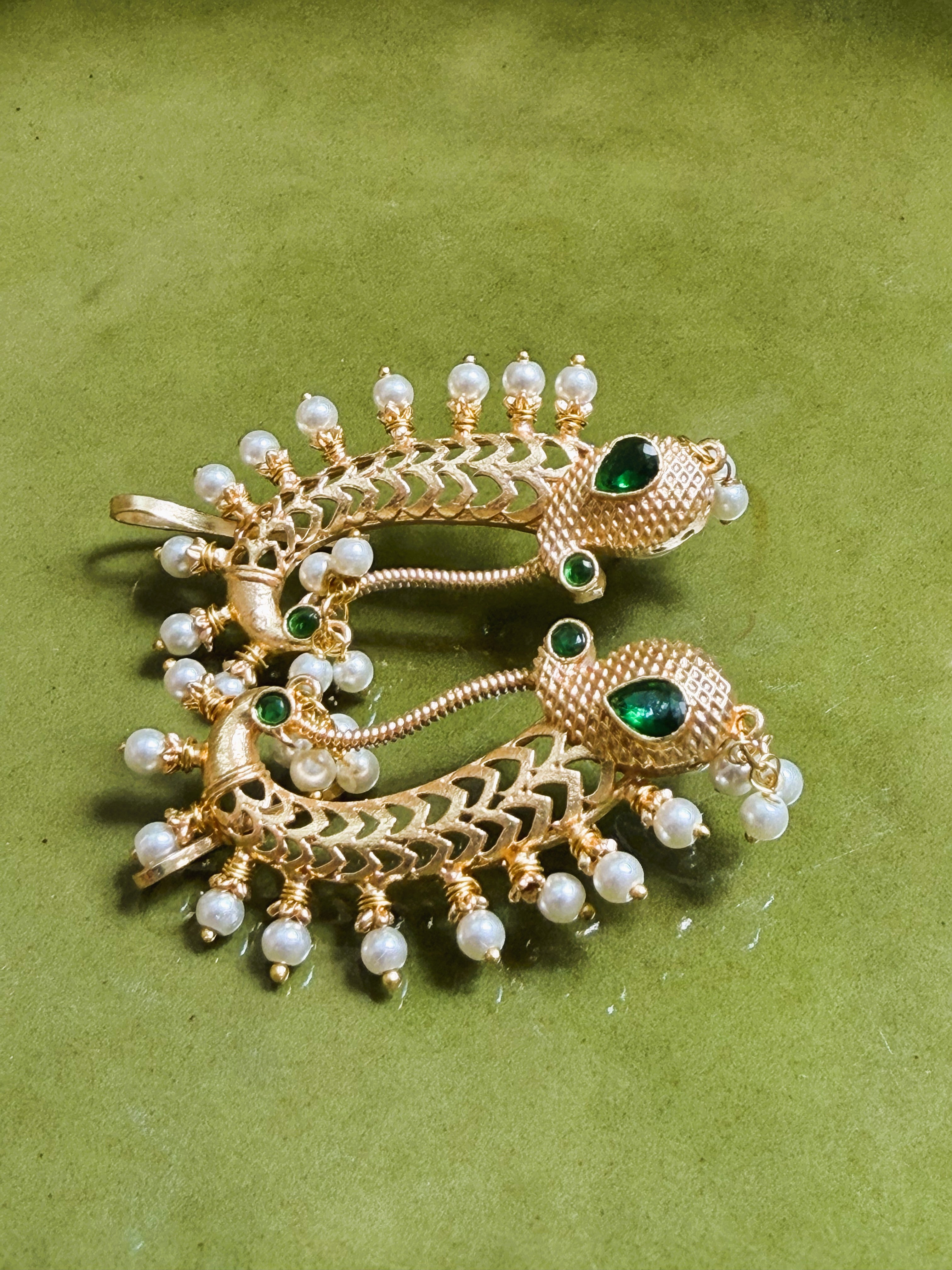Traditional gold earrings with pearl drops and curved design