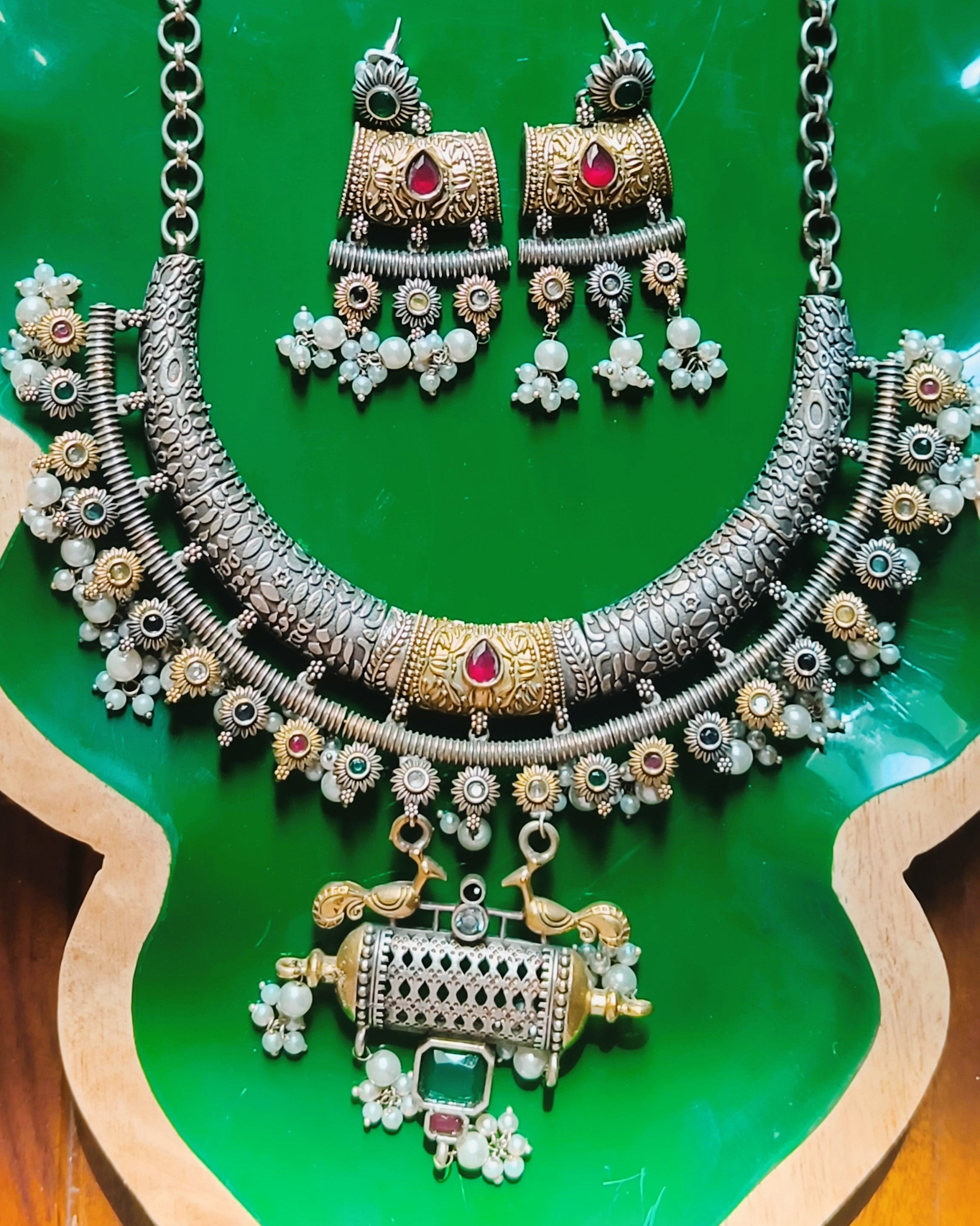 Mughal Baagh dual tone choker necklace and chandelier earrings set styled with bridal ethnic wear showcasing the oxidised silver and gold finish