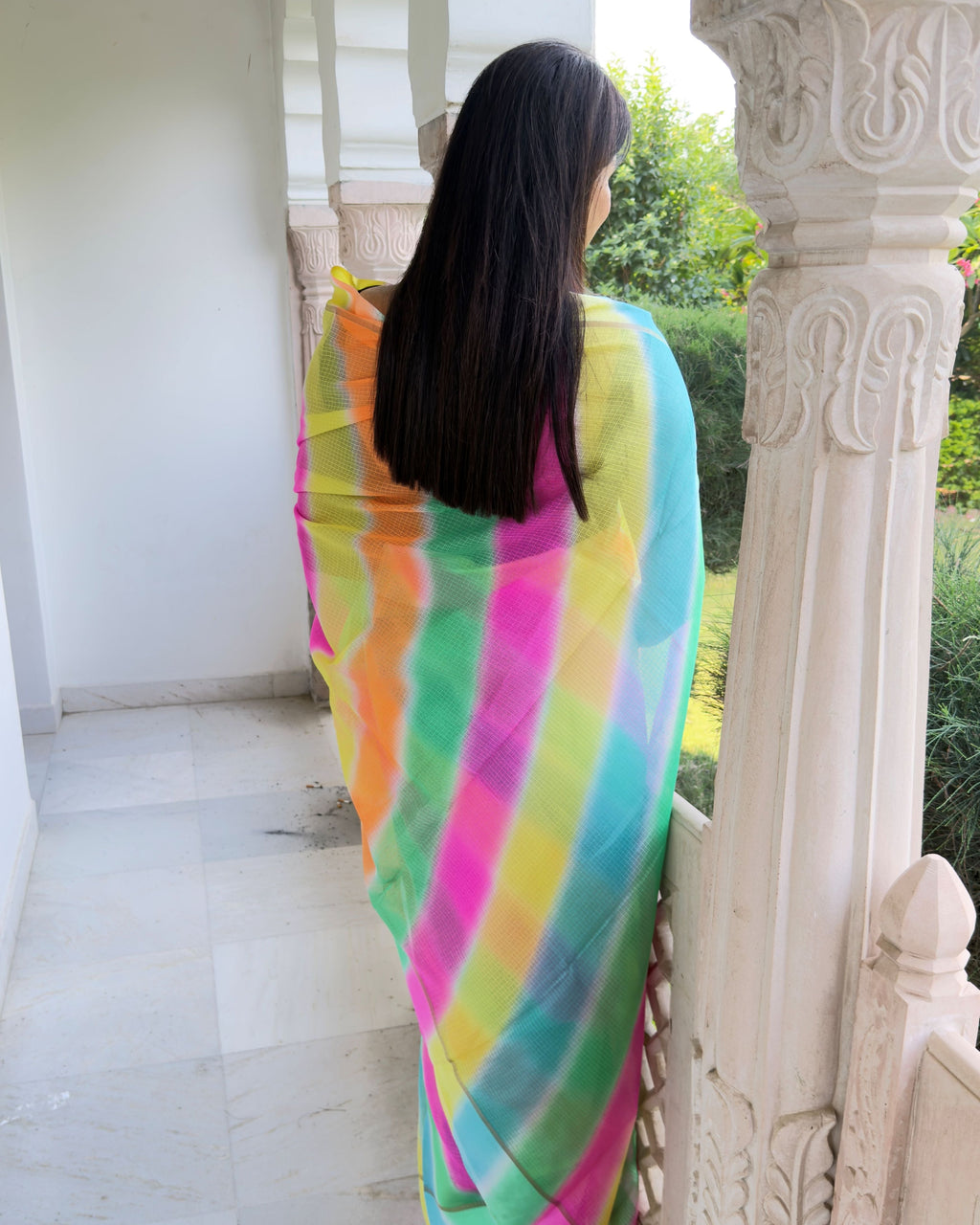 Woman wearing multicolor lehriya semi kota doria saree, draped look for festive occasions