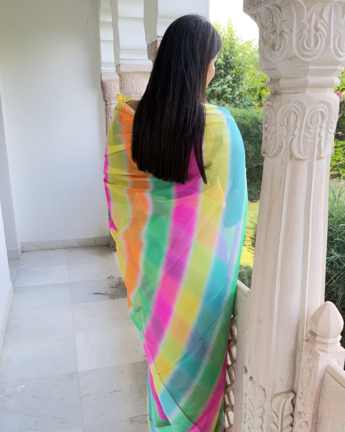 Woman wearing multicolor lehriya semi kota doria saree, draped look for festive occasions