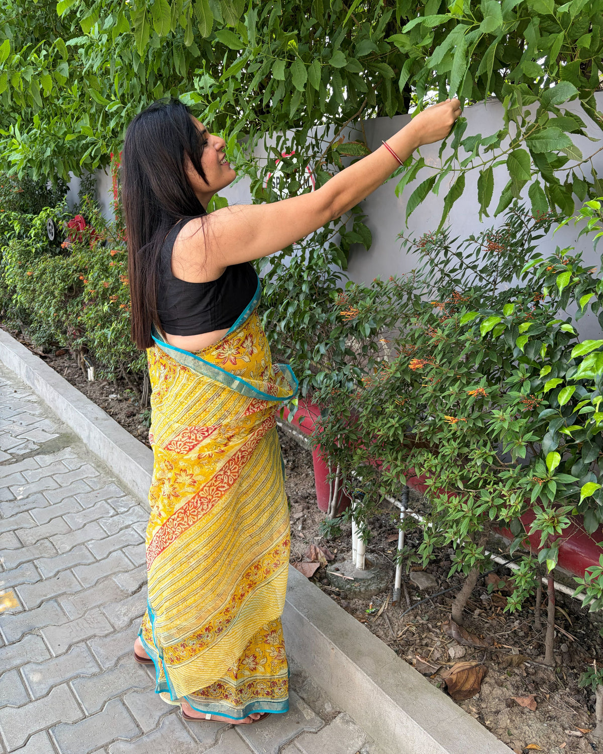 Close-up of multicolour floral print on mustard yellow Kota Doria saree